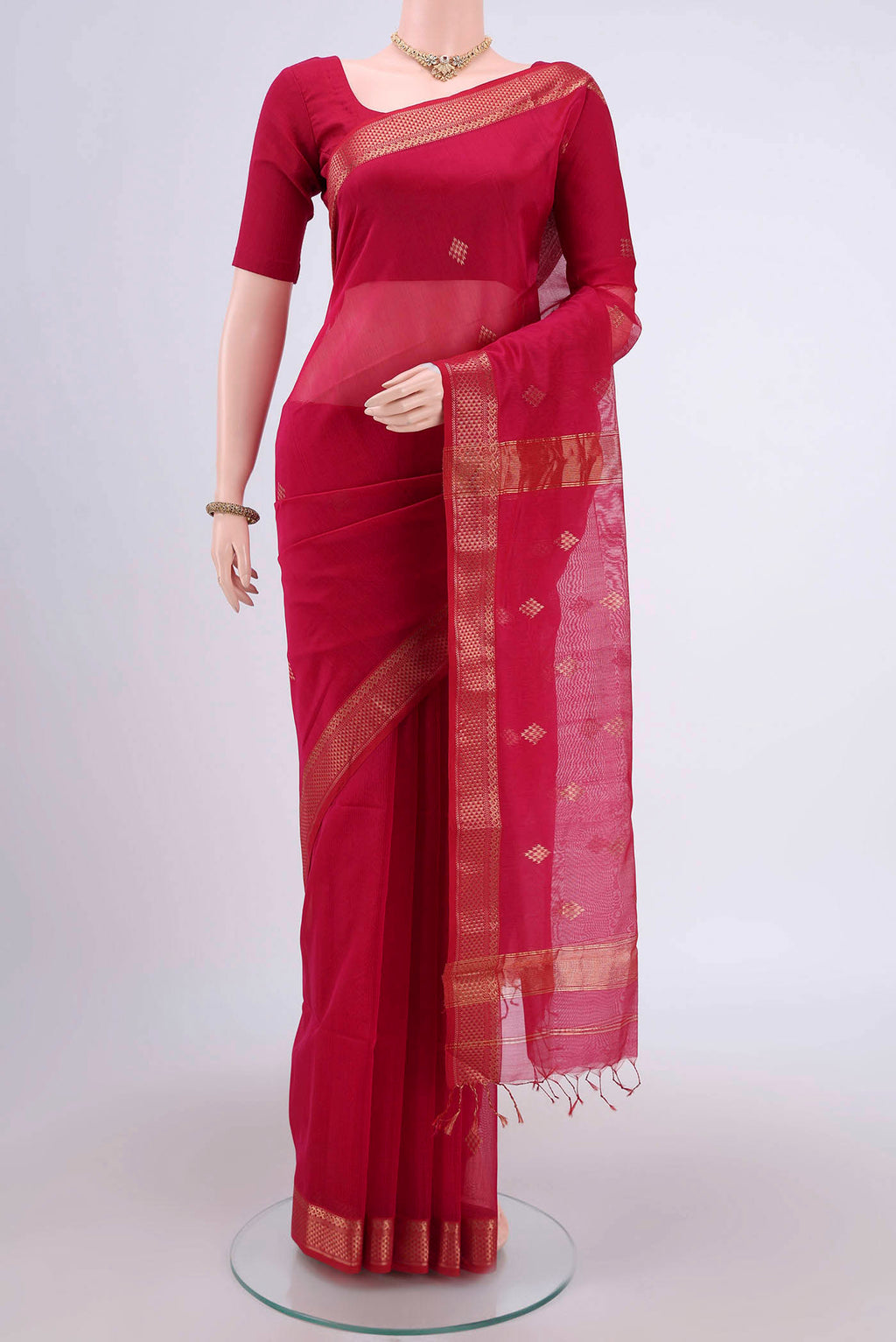Pink Maheshwari Silk Cotton Saree with Stripes on the body and Zari Border.  displayed on a mannequin