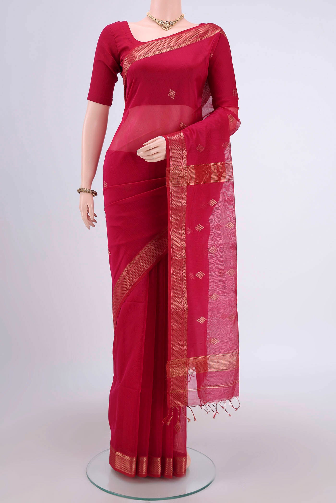 Pink Maheshwari Silk Cotton Saree with Stripes on the body and Zari Border.  displayed on a mannequin