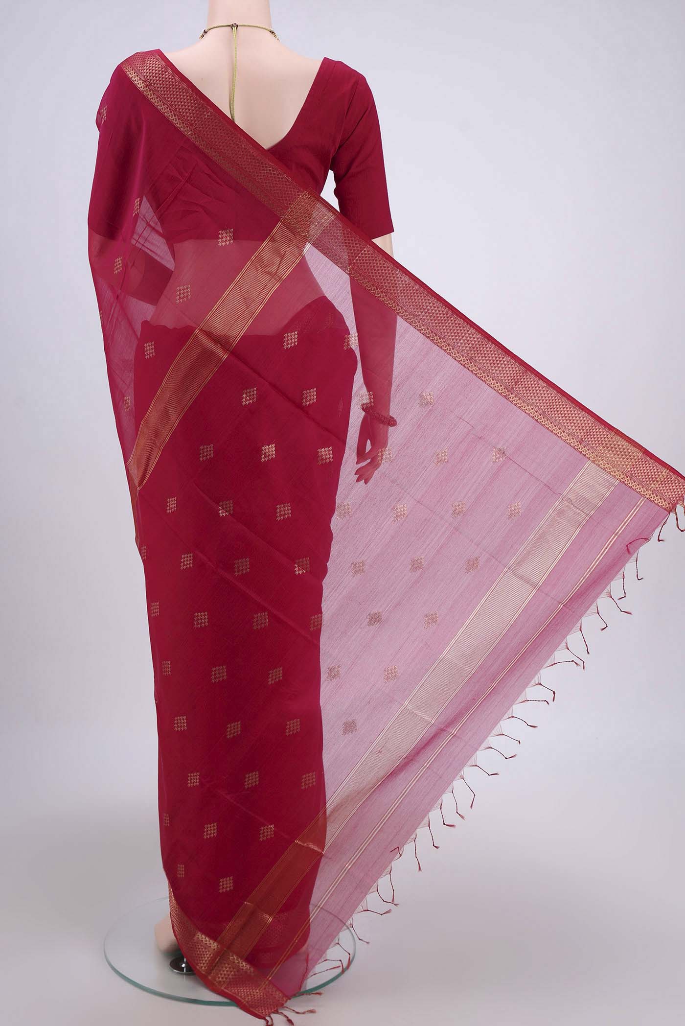 Flat view of Pink Maheshwari Silk Cotton Saree with Stripes on the body and Zari Border. 