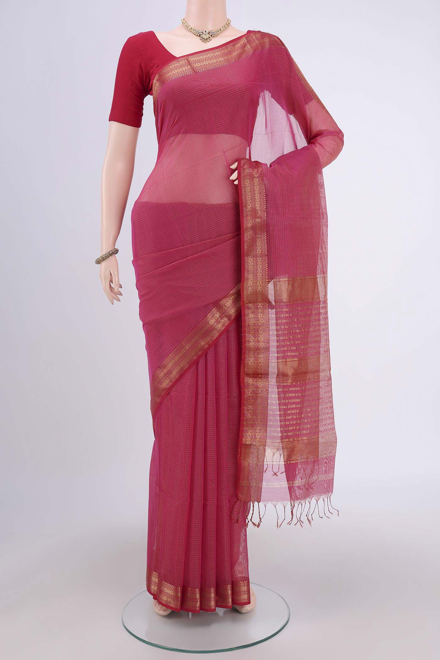 Dark Pink Maheshwari Silk Cotton Saree with Stripes on the body and Zari Border.  displayed on a mannequin