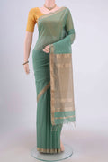 Sage Green Maheshwari Silk Cotton Saree with Stripes on the body and Zari Border.  displayed on a mannequin