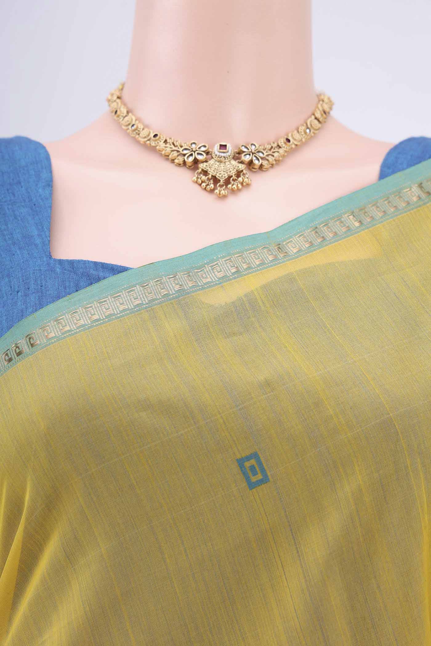 Border image of Lemon Yellow Maheshwari Silk Cotton Saree with Zari And Thread Butta on the body and Zari Border. 