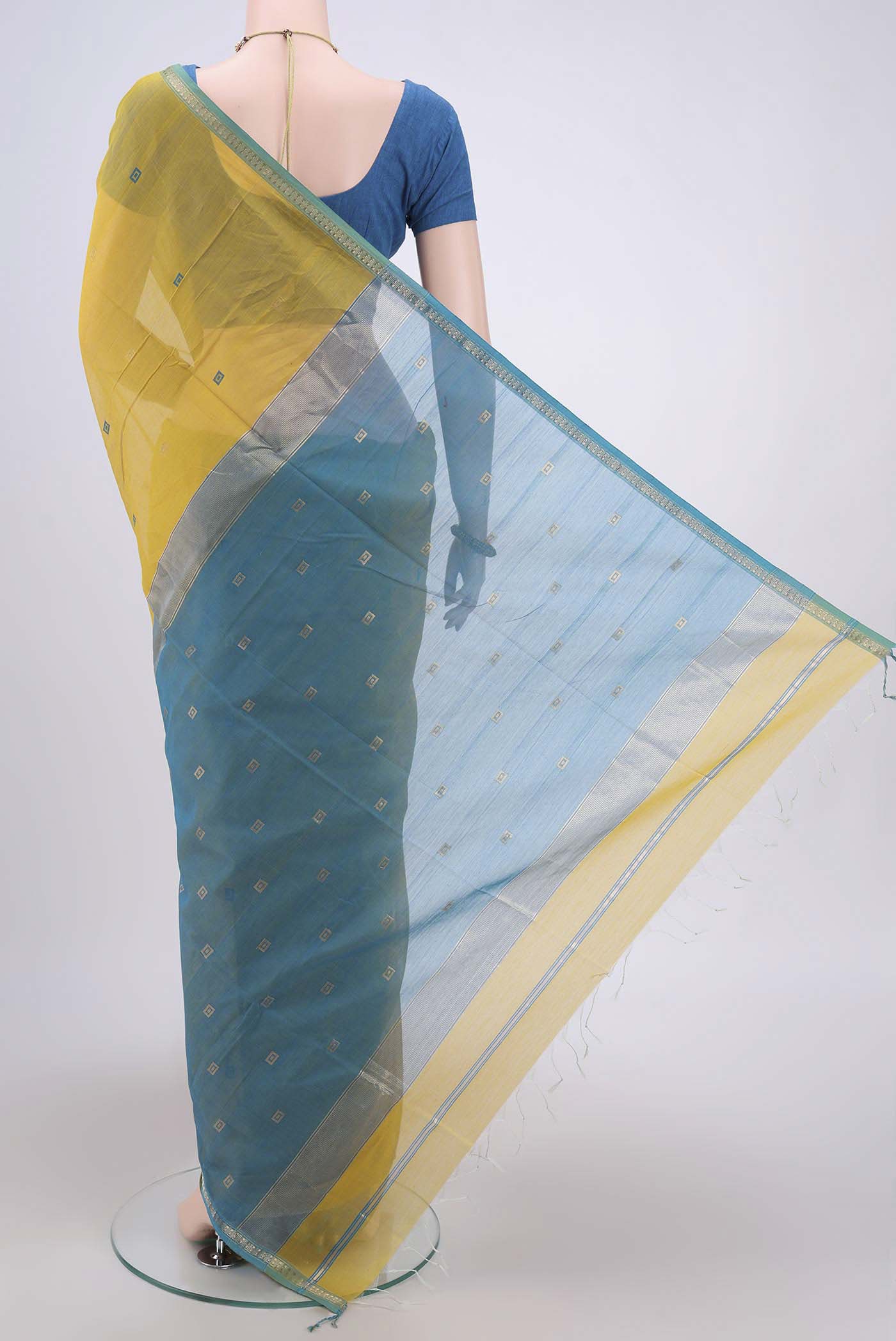 Flat view of Lemon Yellow Maheshwari Silk Cotton Saree with Zari And Thread Butta on the body and Zari Border. 