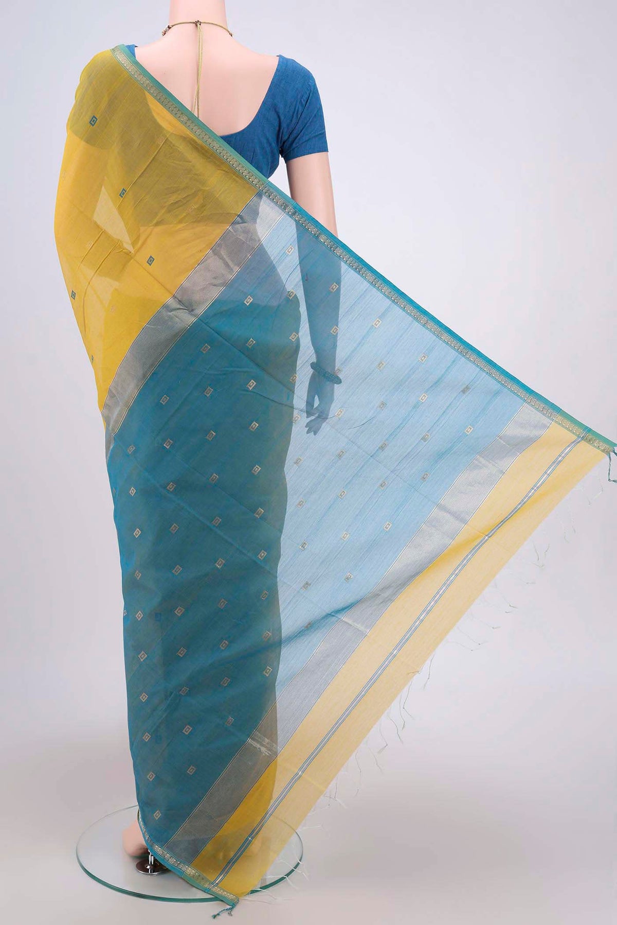 Flat view of Lemon Yellow Maheshwari Silk Cotton Saree with Zari And Thread Butta on the body and Zari Border. 
