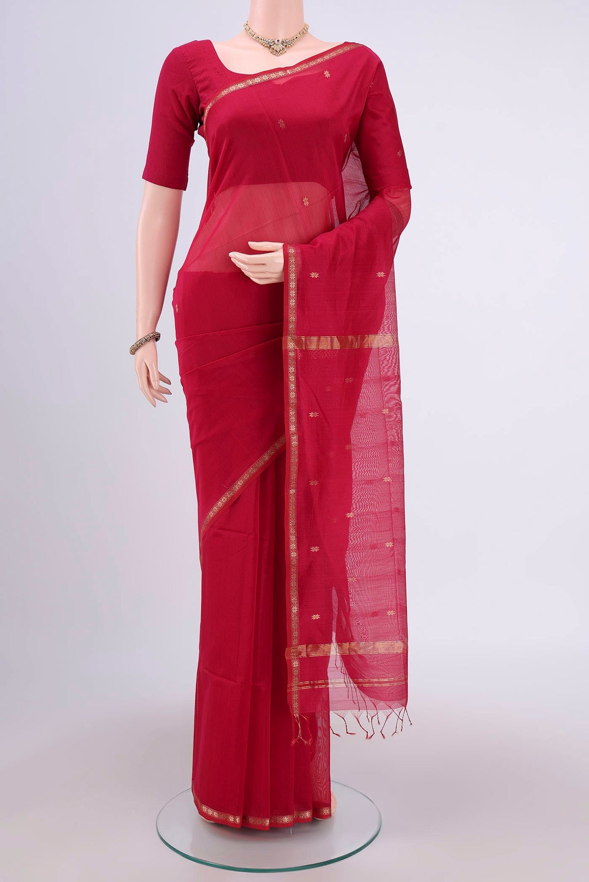 Rani Pink Maheshwari Silk Cotton Saree with Plain Body and Zari Border.  displayed on a mannequin