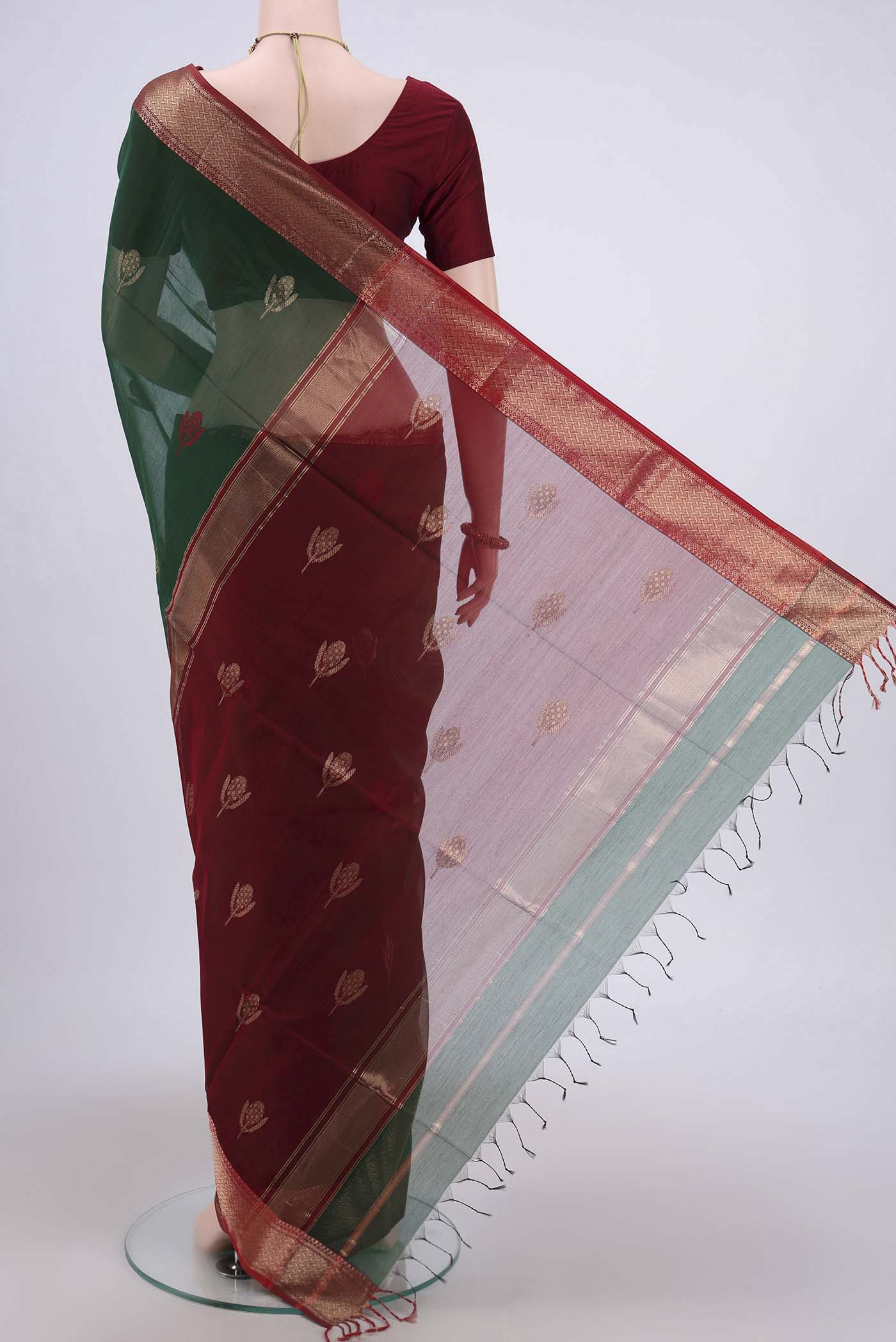 Flat view of Bottle Green Maheshwari Silk Cotton Saree with Stripes on the body and Zari Border. 