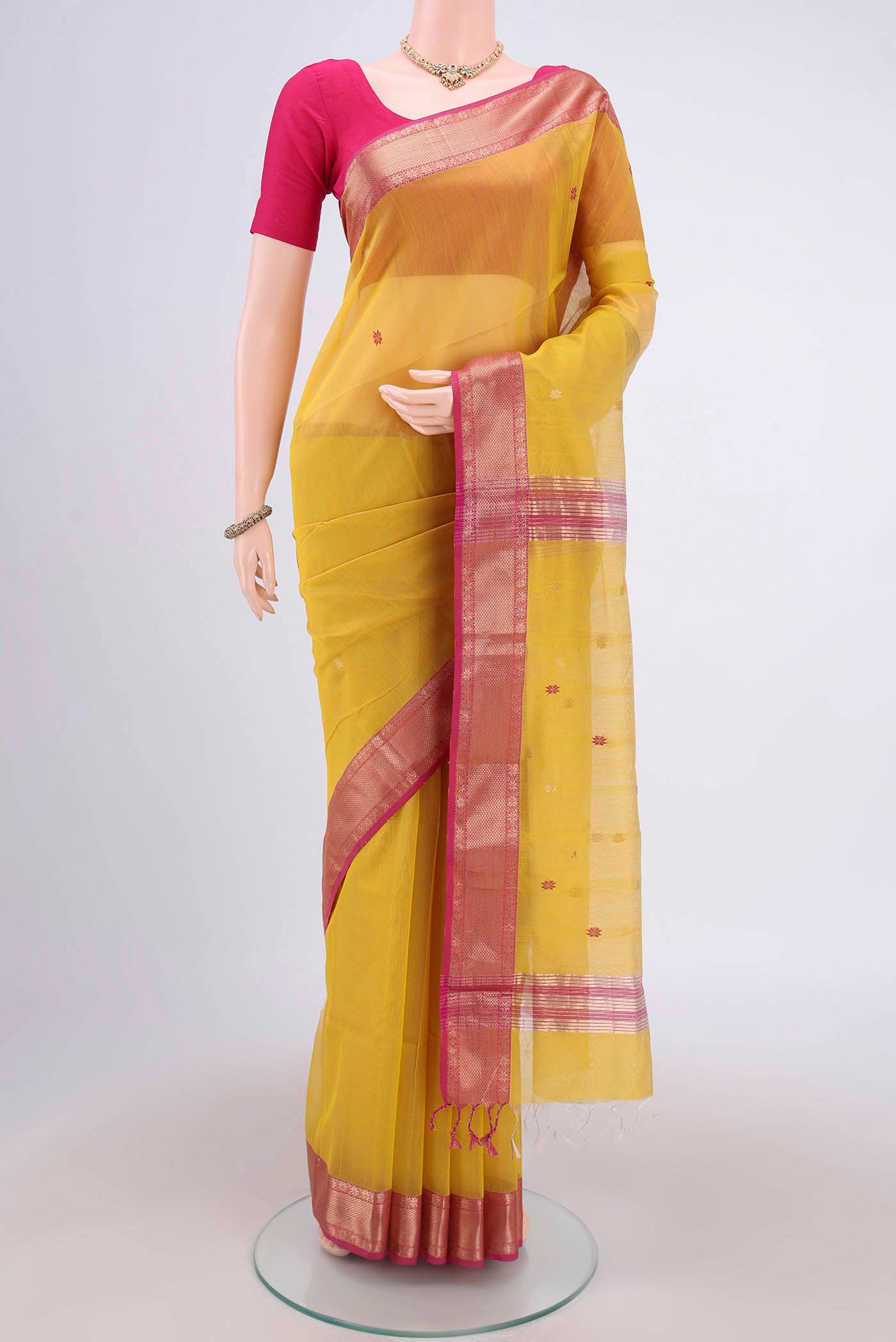 Yellow Maheshwari Silk Cotton Saree with Plain Body and Zari Border.  displayed on a mannequin