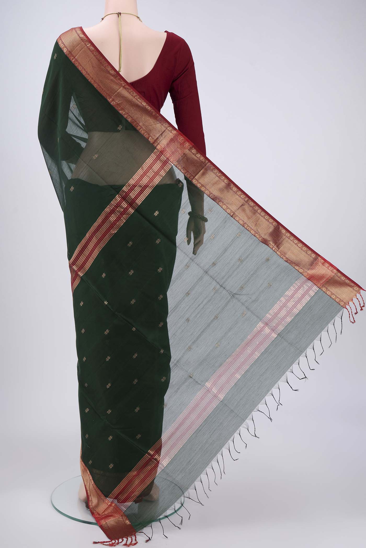 Flat view of Bottle Green Maheshwari Silk Cotton Saree with Plain Body and Zari Border. 