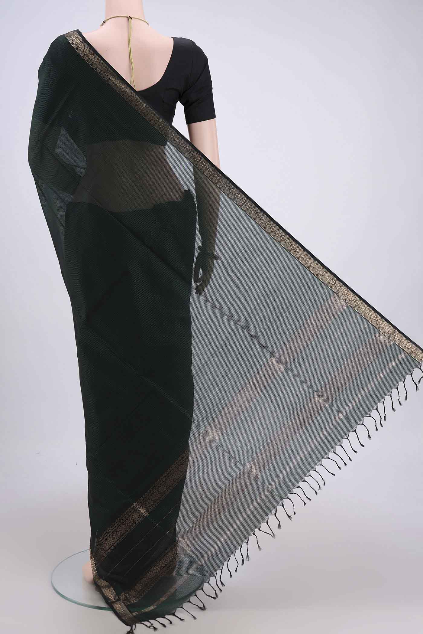 Flat view of Bottle Green Maheshwari Silk Cotton Saree with Plain Body and Zari Border. 