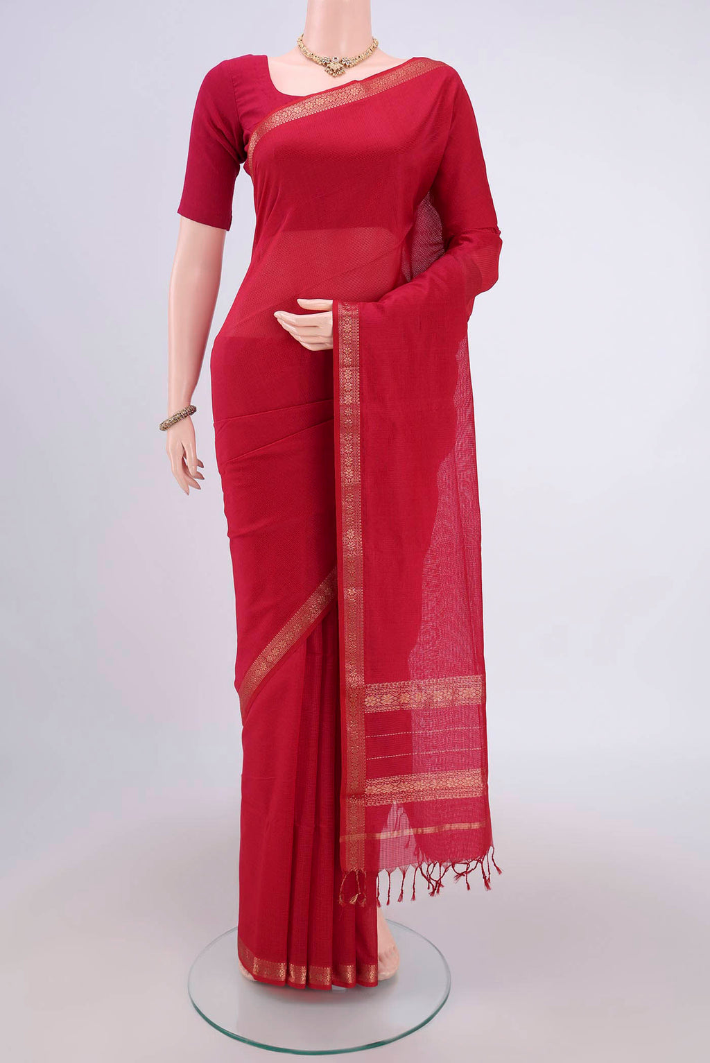 Maroon Maheshwari Silk Cotton Saree with Plain Body and Zari Border.  displayed on a mannequin