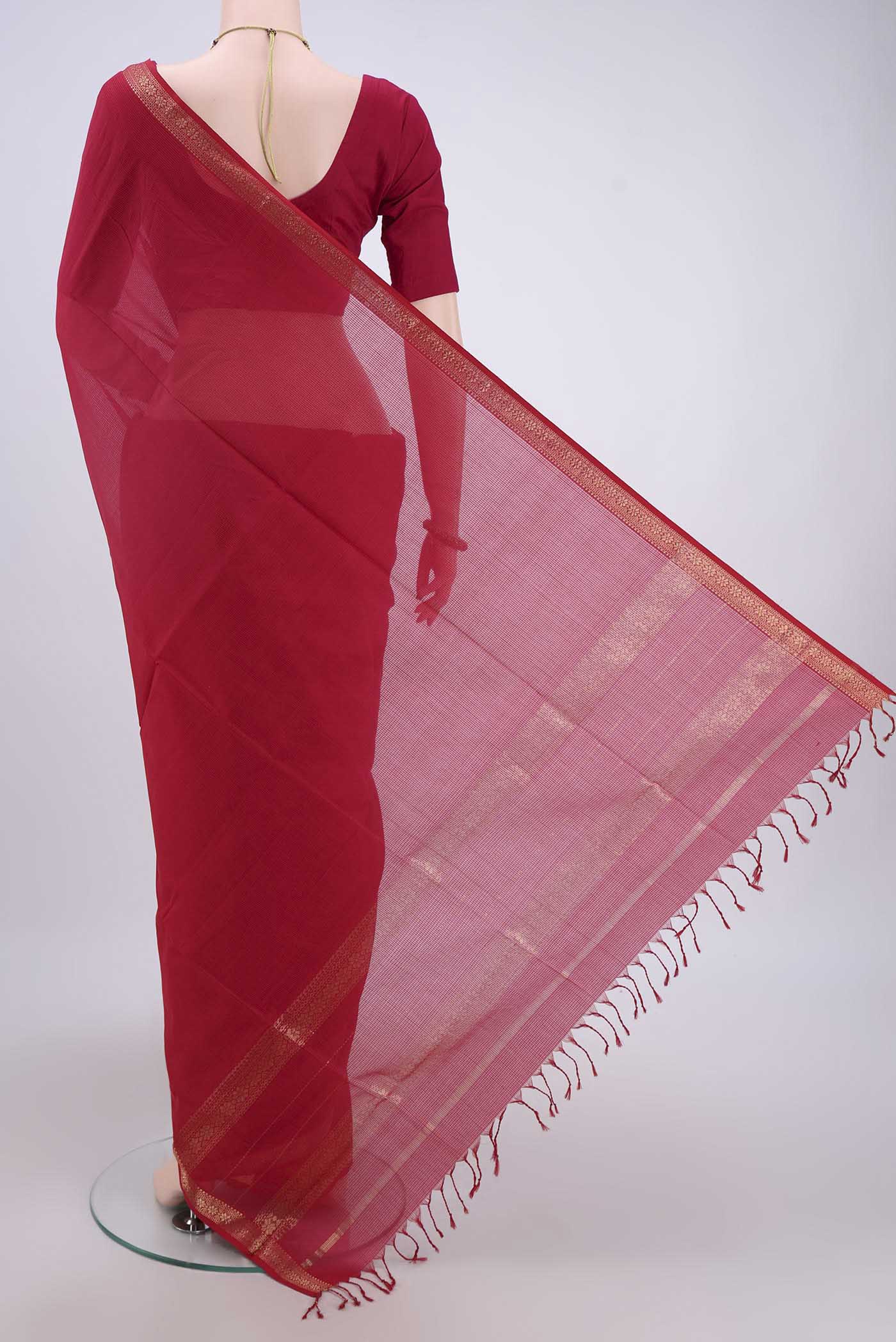 Flat view of Maroon Maheshwari Silk Cotton Saree with Plain Body and Zari Border. 