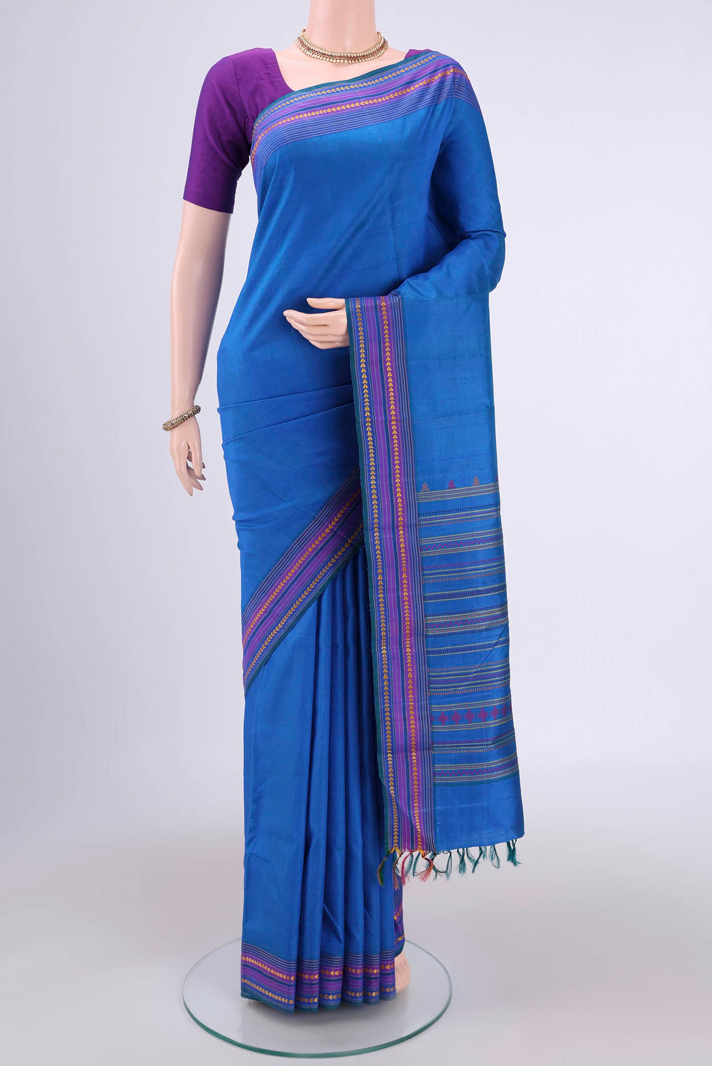 Blue Kanchipuram Saree with Plain Body and Thread Border.  displayed on a mannequin