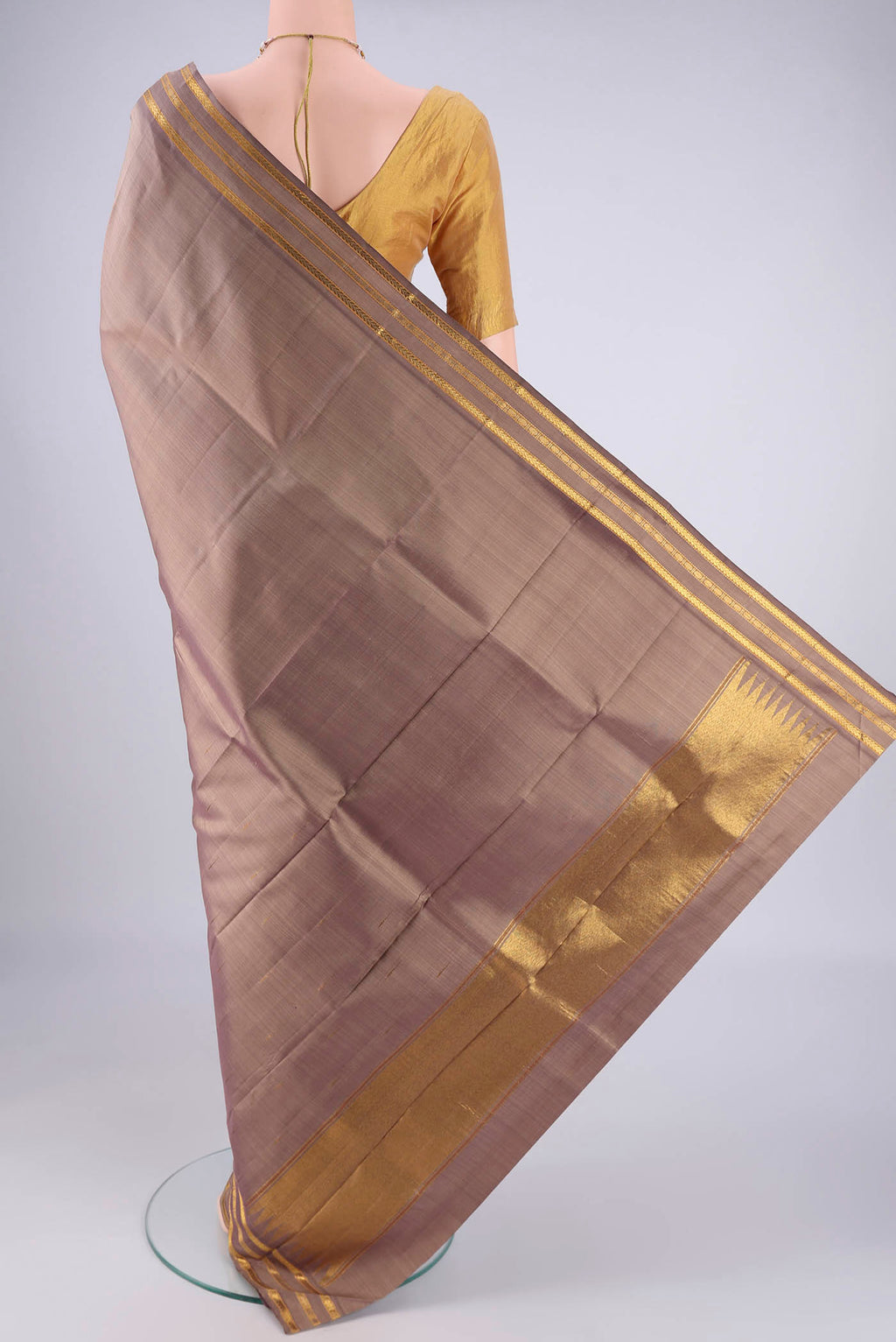 Flat view of Brown Kanchipuram Silk Saree with Plain Body and Zari Border. 