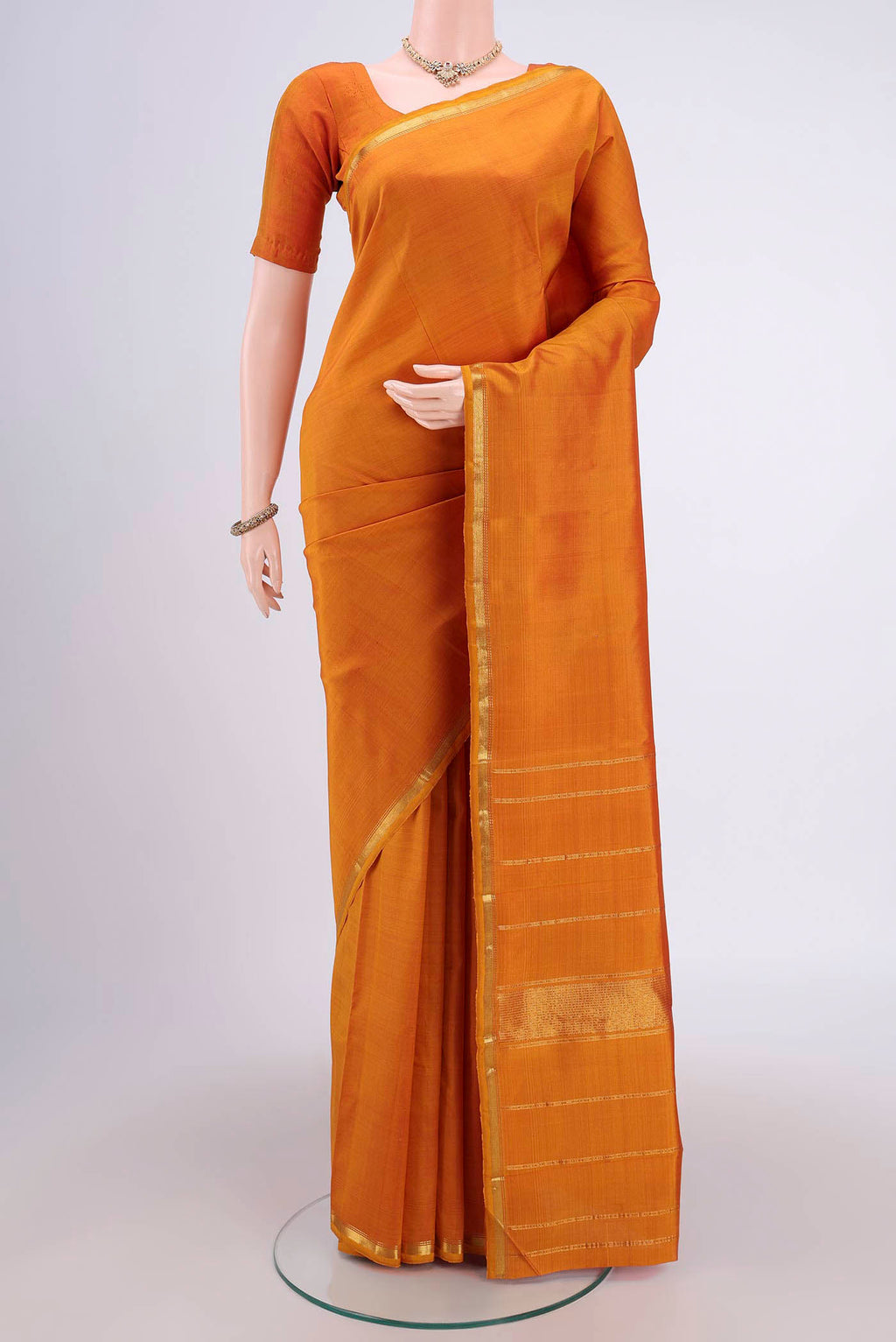 Mustard Dual Tone Kanjivaram Silk Saree with Plain Body and Zari Border.  displayed on a mannequin