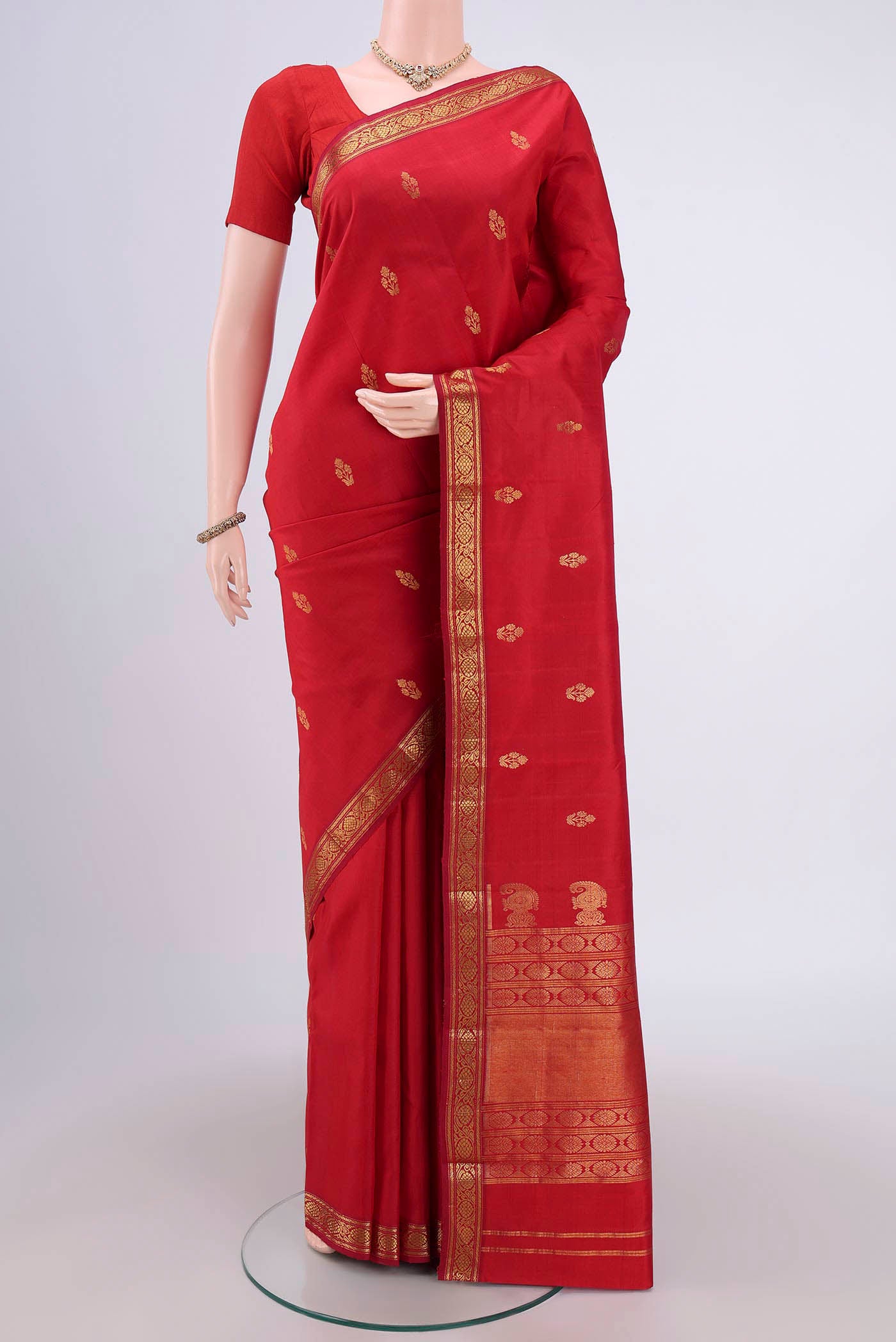 Maroon Dual Tone Kanjivaram Silk Saree with Zari Butta on the body and Zari Border.  displayed on a mannequin