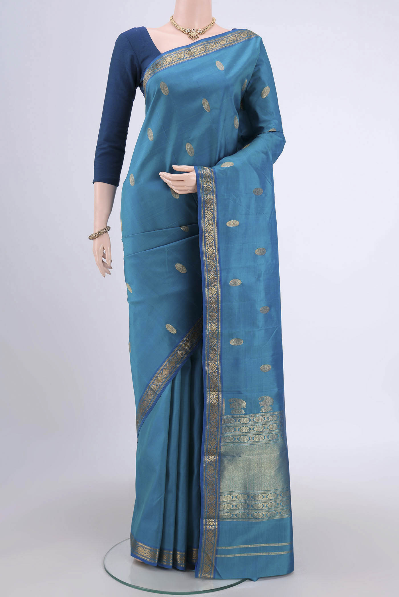 Blue Dual Tone Kanjivaram Silk Saree with Zari Butta on the body and Zari Border.  displayed on a mannequin
