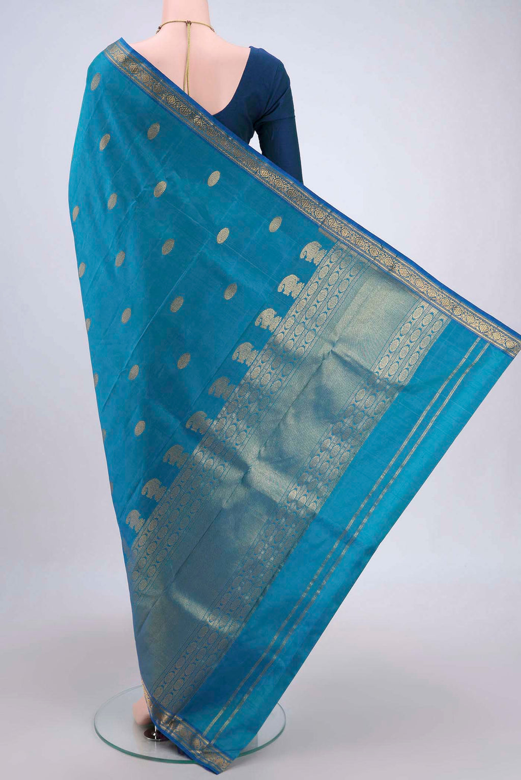 Flat view of Blue Dual Tone Kanjivaram Silk Saree with Zari Butta on the body and Zari Border. 