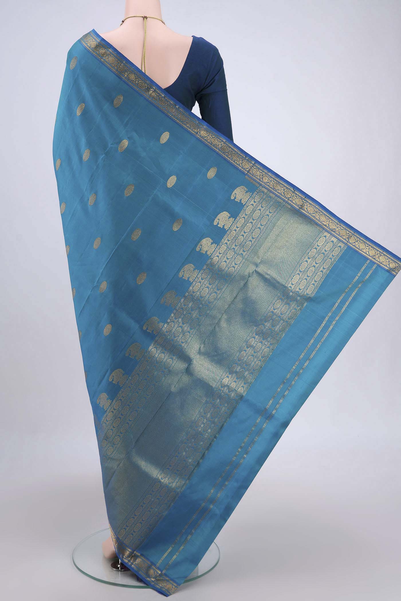 Flat view of Blue Dual Tone Kanjivaram Silk Saree with Zari Butta on the body and Zari Border. 