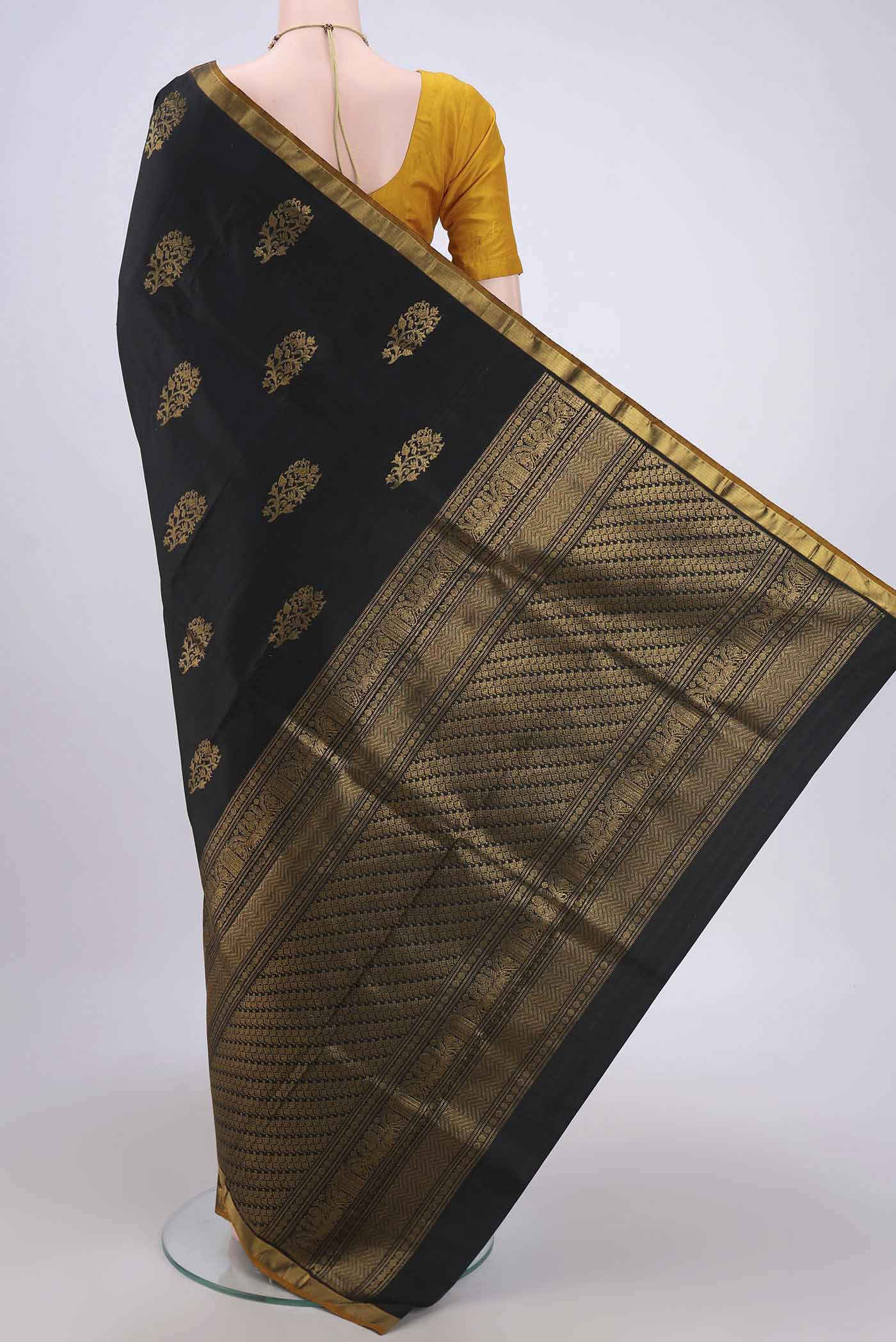 Flat view of Black Dual Tone Kanchipuram Silk Saree with Zari Butta on the body and Zari Border. 