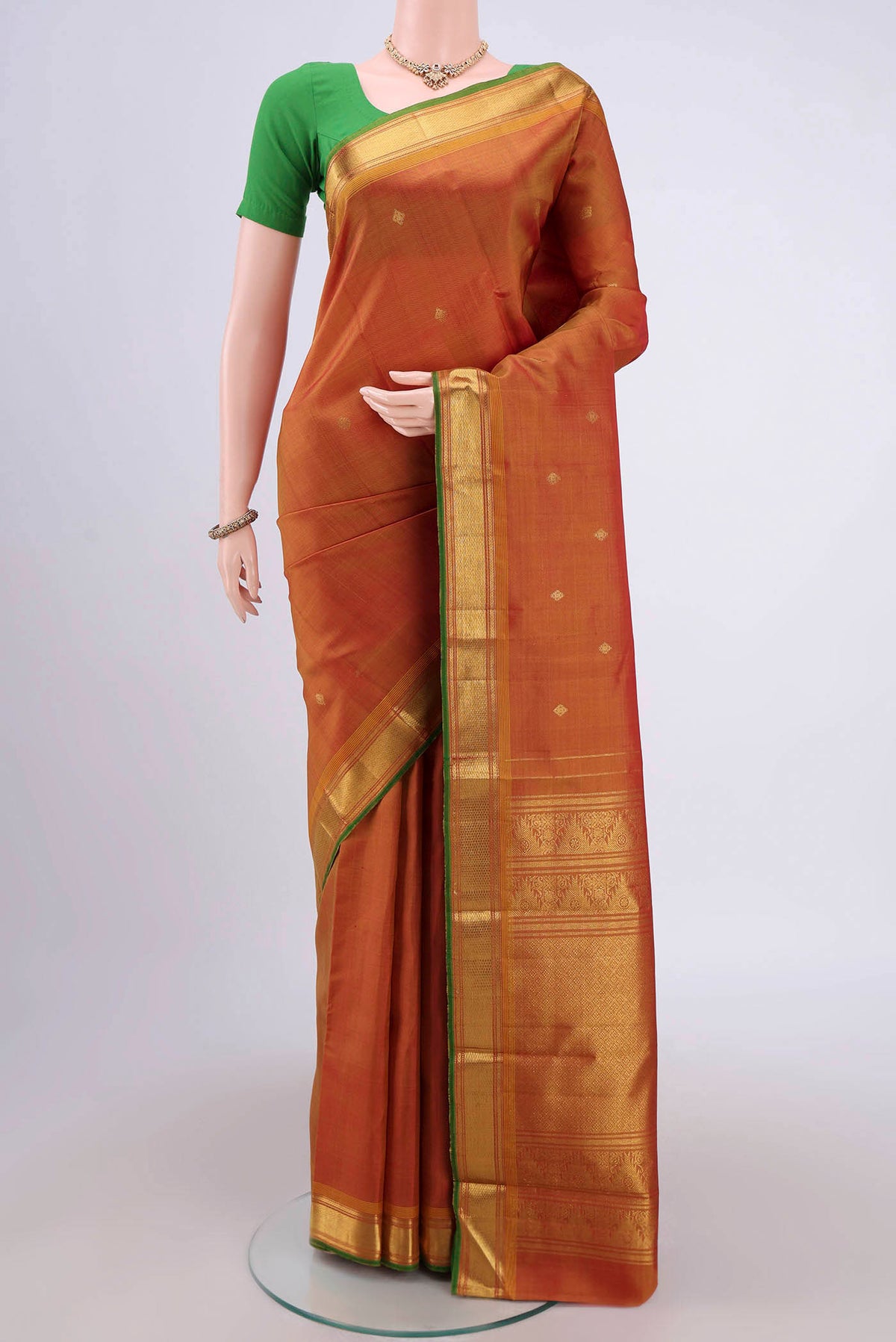 Blue with Green Dual Tone Kanjivaram Silk Saree with Zari Butta on the body and Zari Border.  displayed on a mannequin
