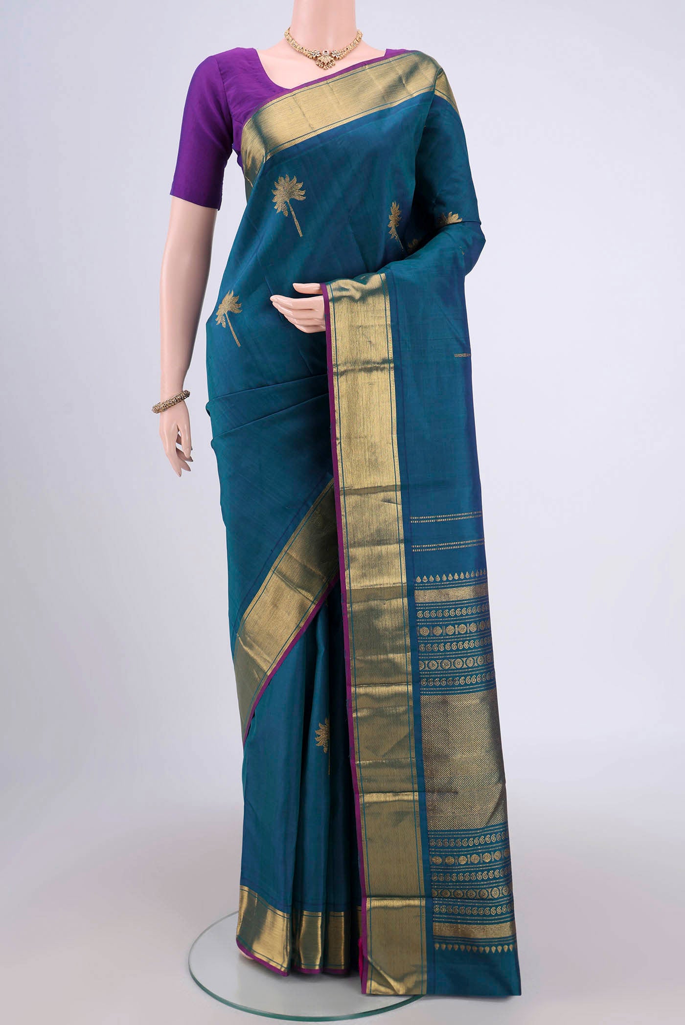 Peacock Blue Dual Tone Kanjivaram Silk Saree with Zari Butta on the body and Zari Border.  displayed on a mannequin