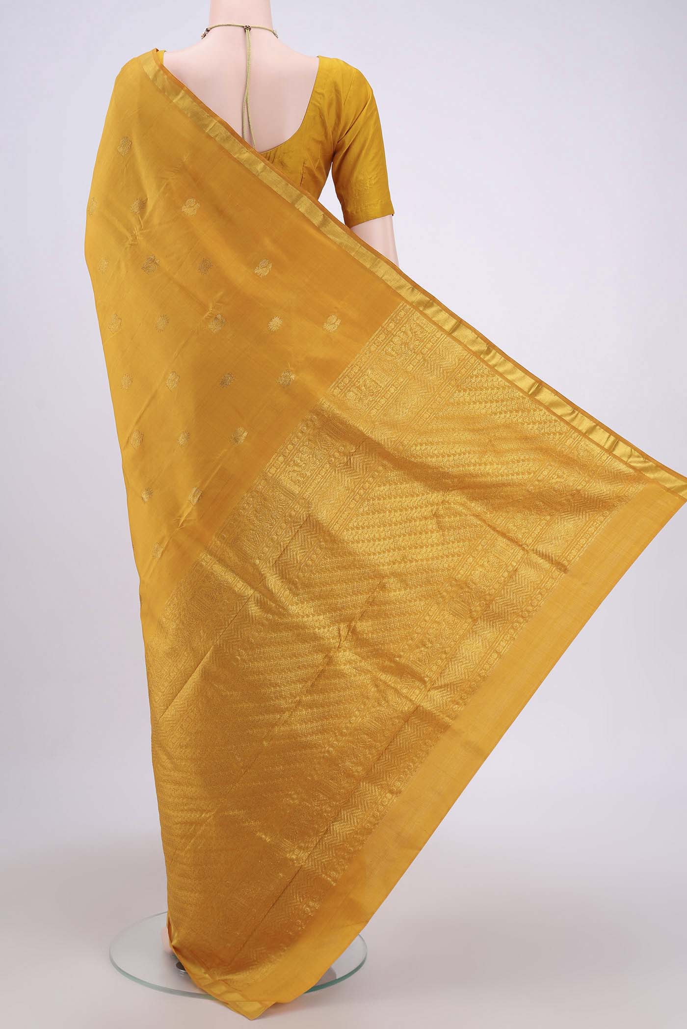 Flat view of Mustard Dual Tone Kanchipuram Silk Saree with Zari Butta on the body and Zari Border. 