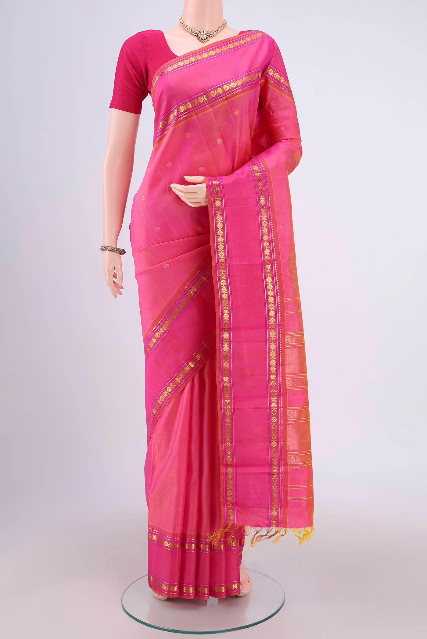 Pink Dual Tone Kanchipuram Silk Saree with Zari Butta on the body and Zari Border.  displayed on a mannequin