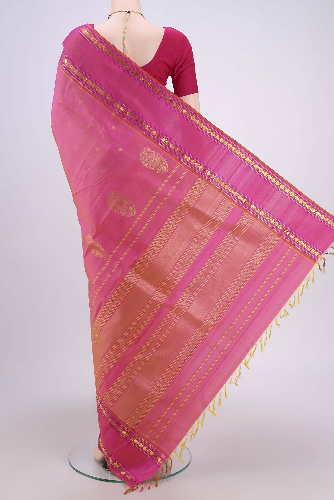Flat view of Pink Dual Tone Kanchipuram Silk Saree with Zari Butta on the body and Zari Border. 
