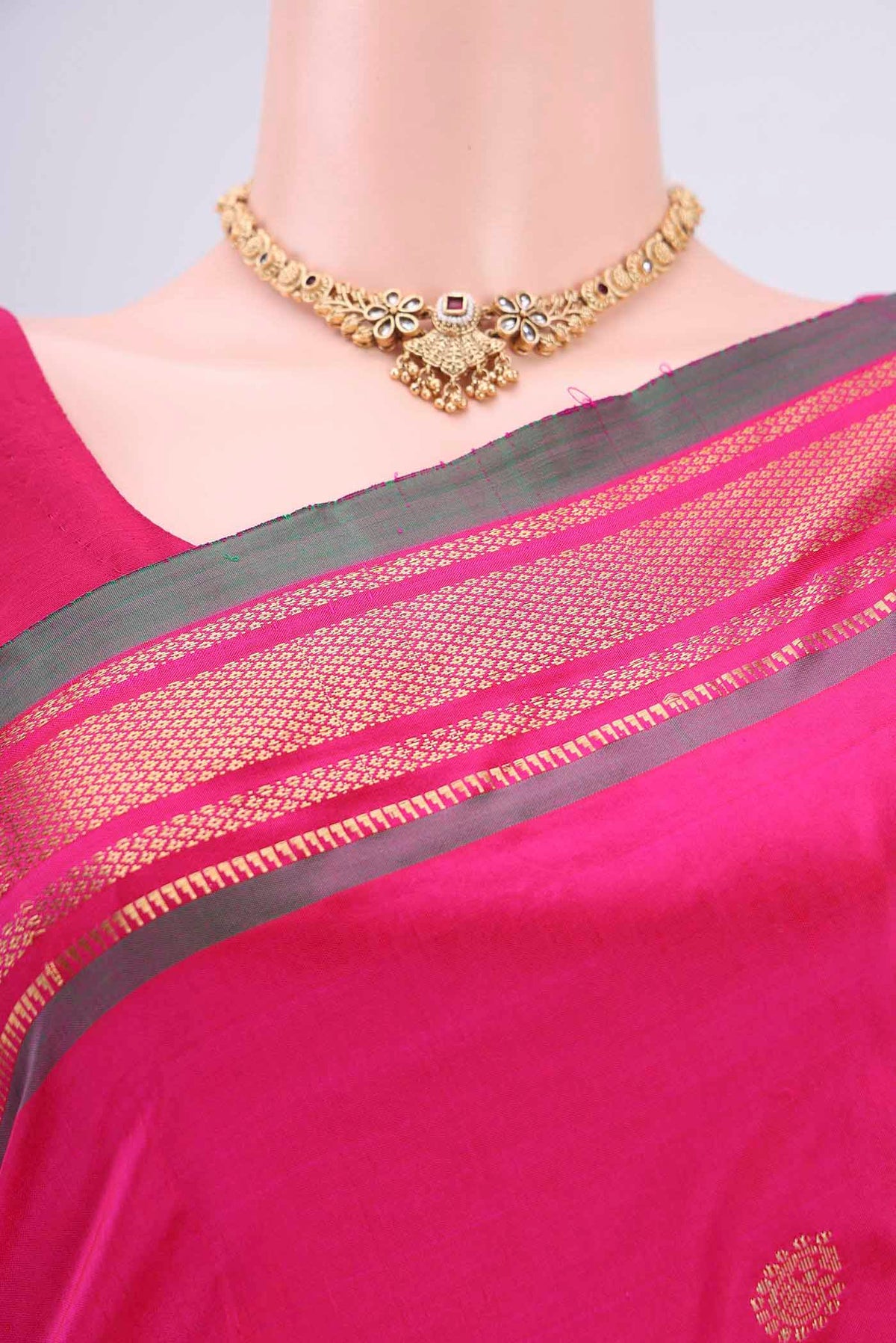 Border image of Rani Pink Soft Silk Saree with Zari Butta on the body and Zari Border. 