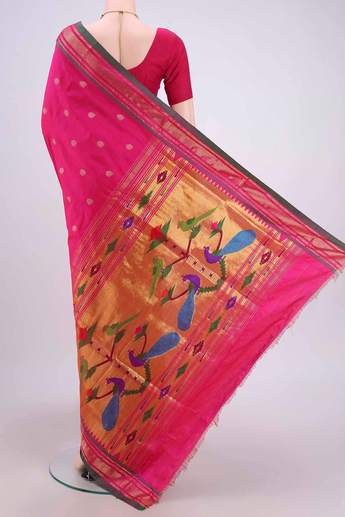 Flat view of Rani Pink Soft Silk Saree with Zari Butta on the body and Zari Border. 