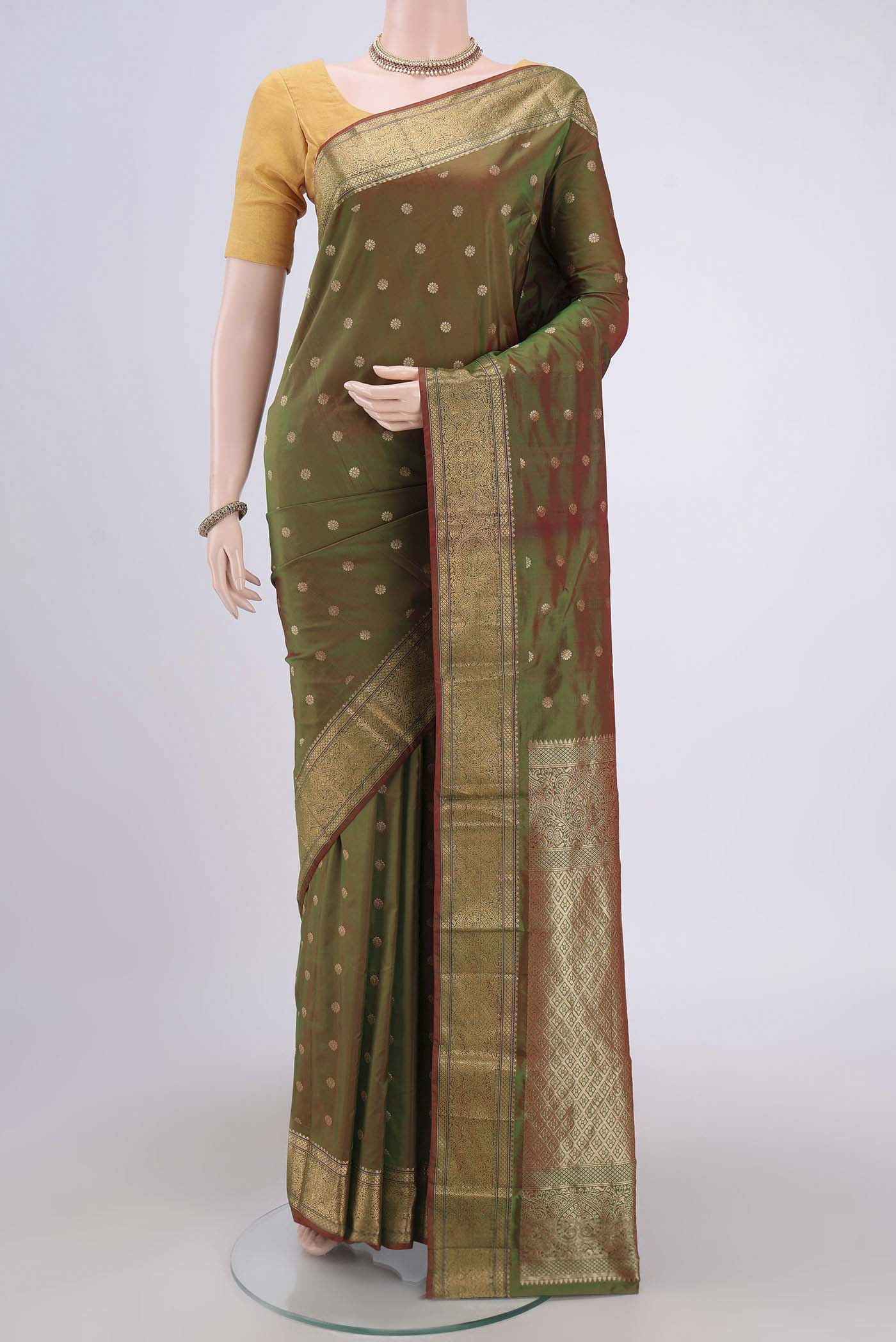 Light Green Blended Bangalore Silk Saree with Zari Butta on the body and Zari Border.  displayed on a mannequin