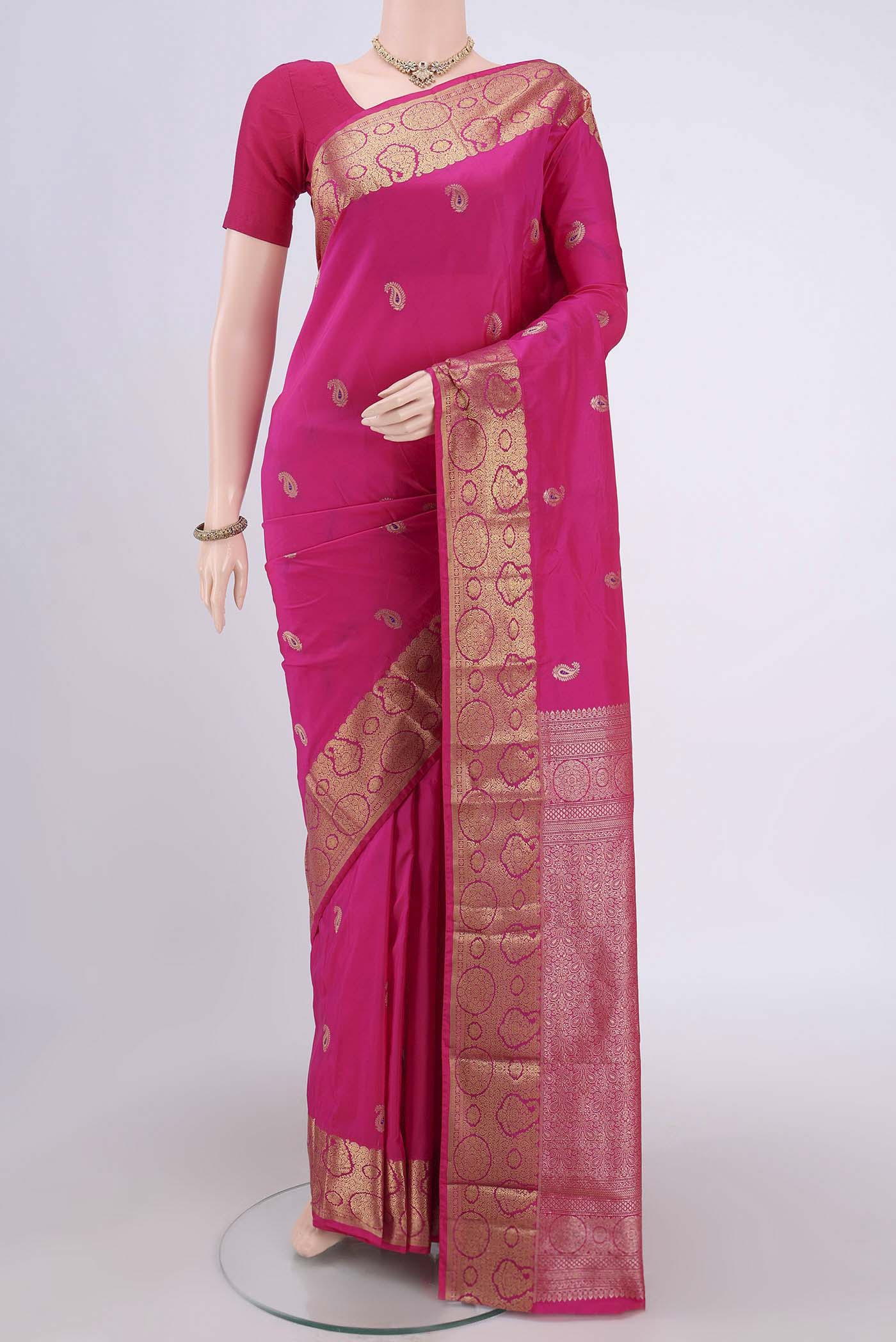 Rani Pink Blended Bangalore Silk Saree with Zari Butta on the body and Zari Border.  displayed on a mannequin