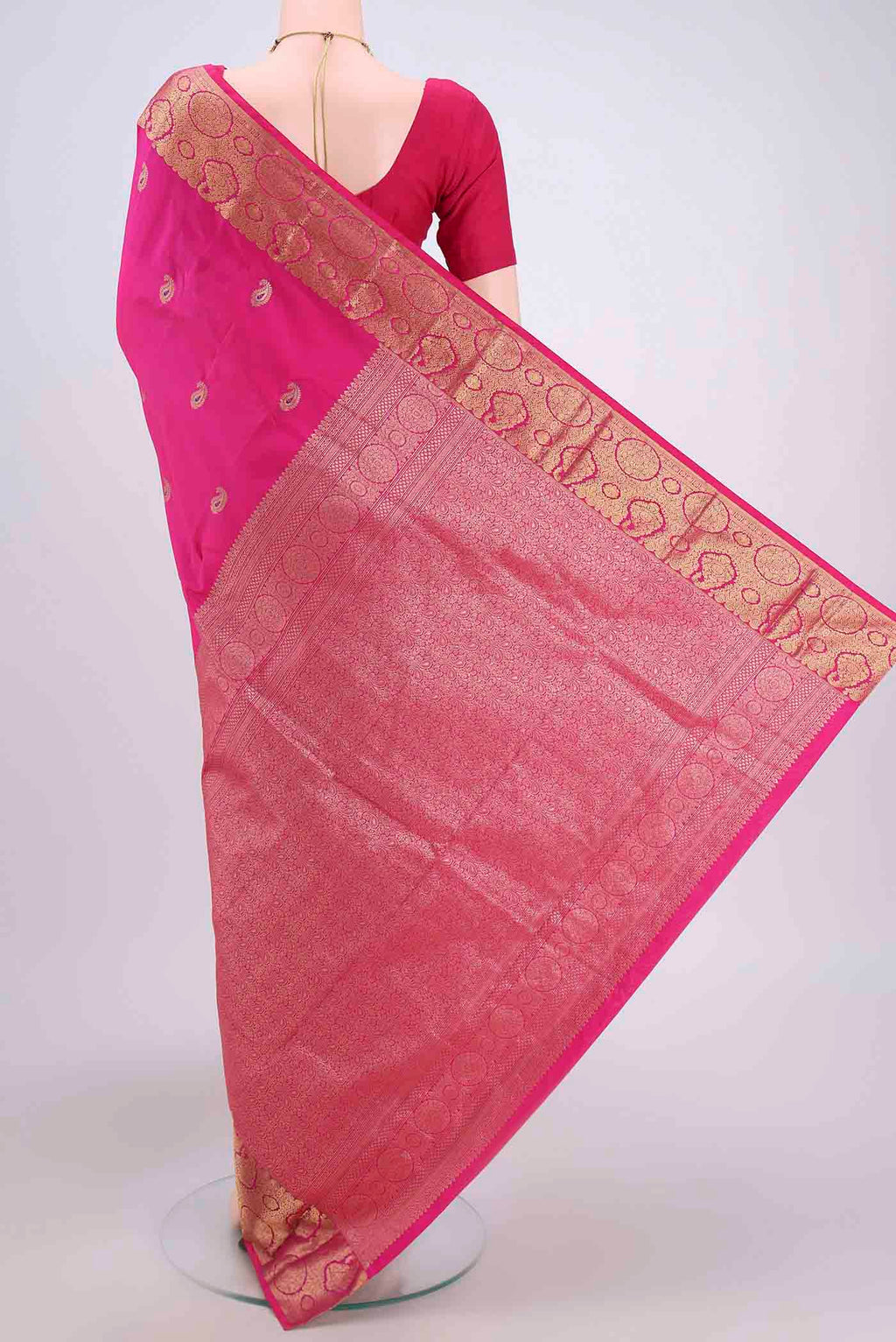Flat view of Rani Pink Blended Bangalore Silk Saree with Zari Butta on the body and Zari Border. 