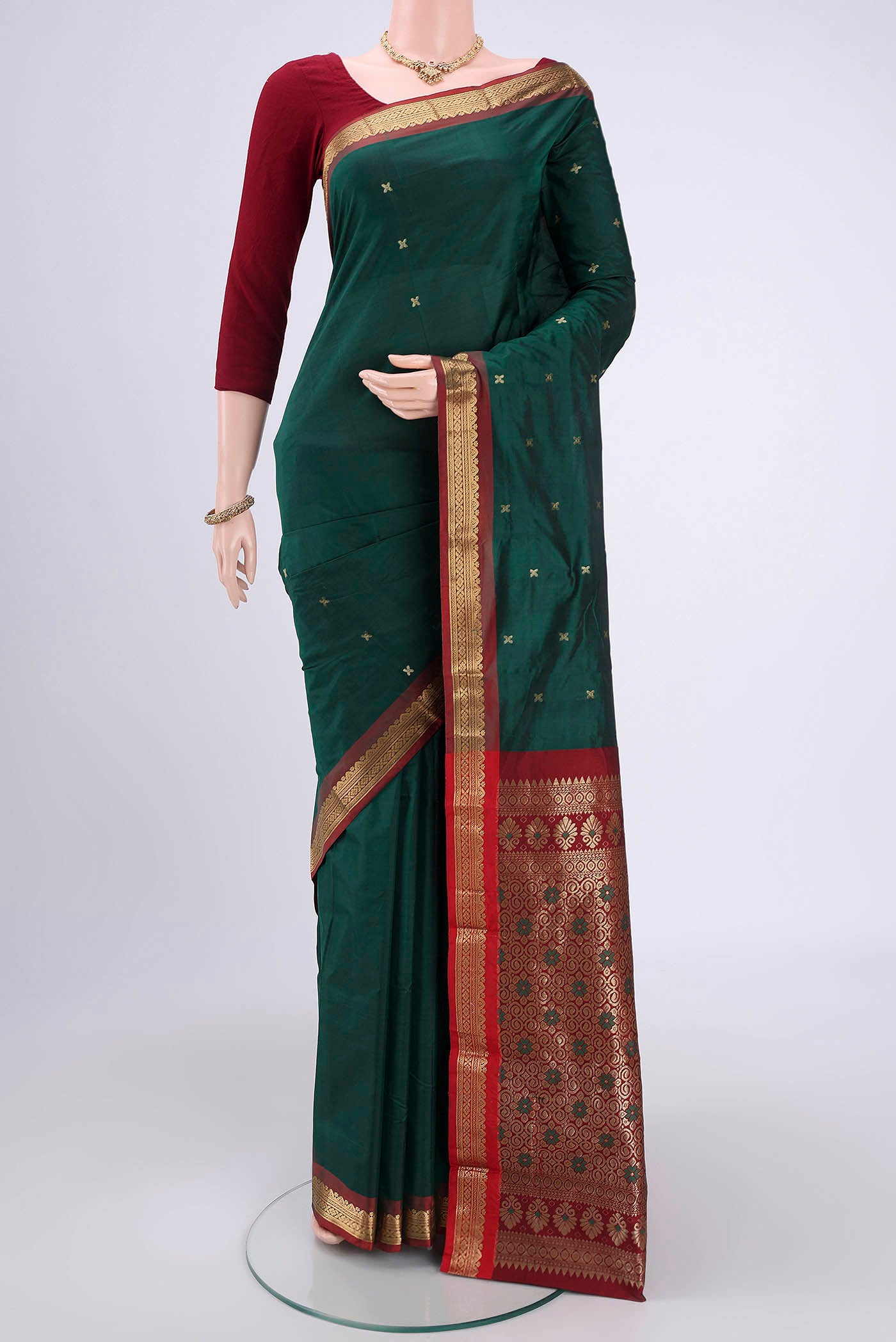 Bottle Green Blended Bangalore Silk Saree with Zari Butta on the body and Zari Border.  displayed on a mannequin