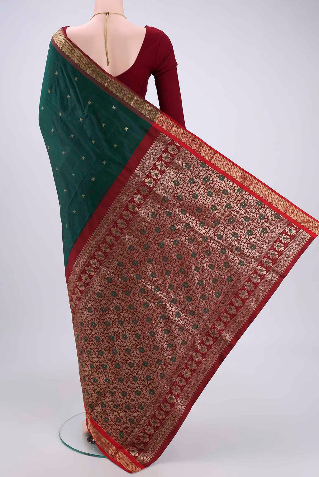 Flat view of Bottle Green Blended Bangalore Silk Saree with Zari Butta on the body and Zari Border. 