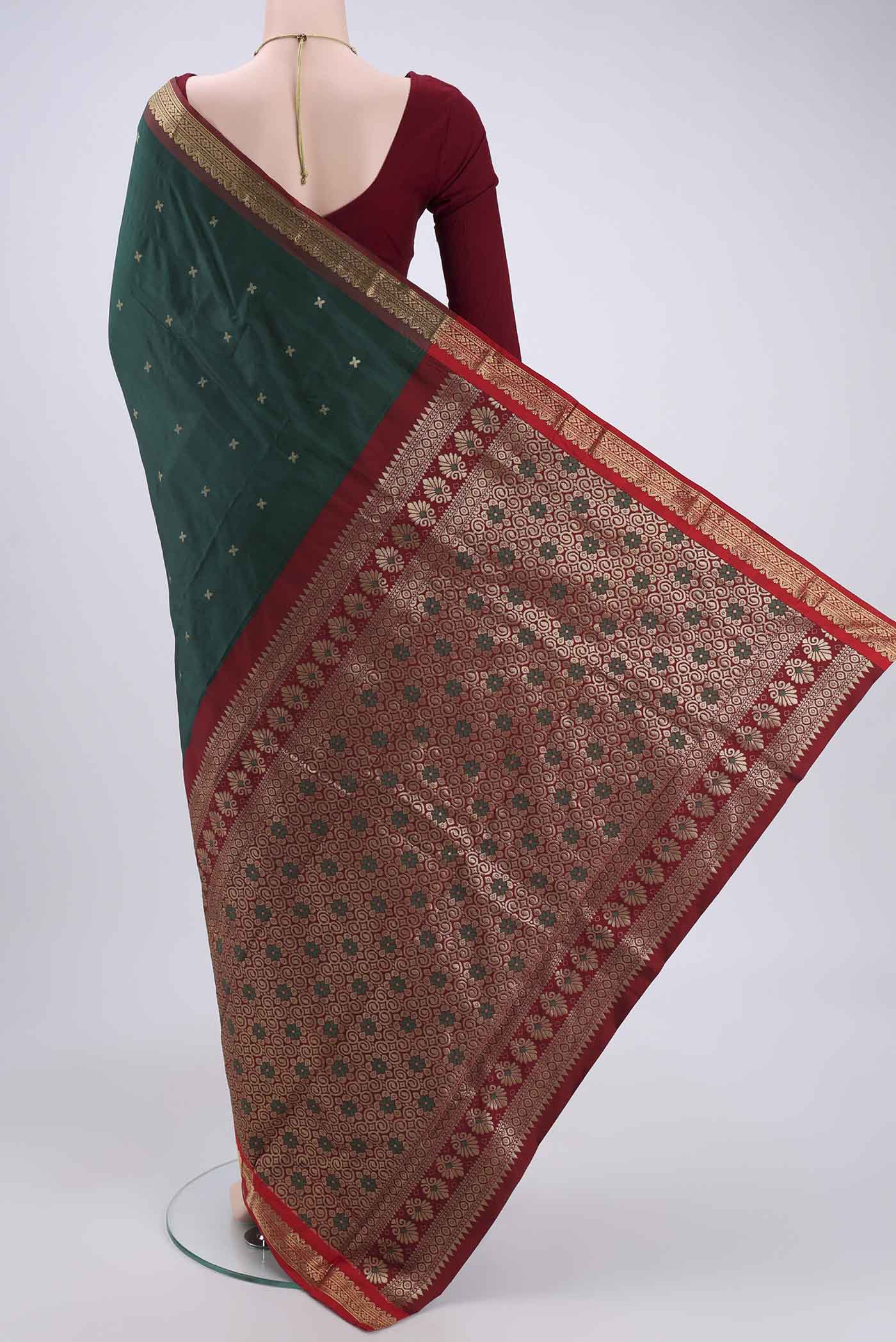 Flat view of Bottle Green Blended Bangalore Silk Saree with Zari Butta on the body and Zari Border. 