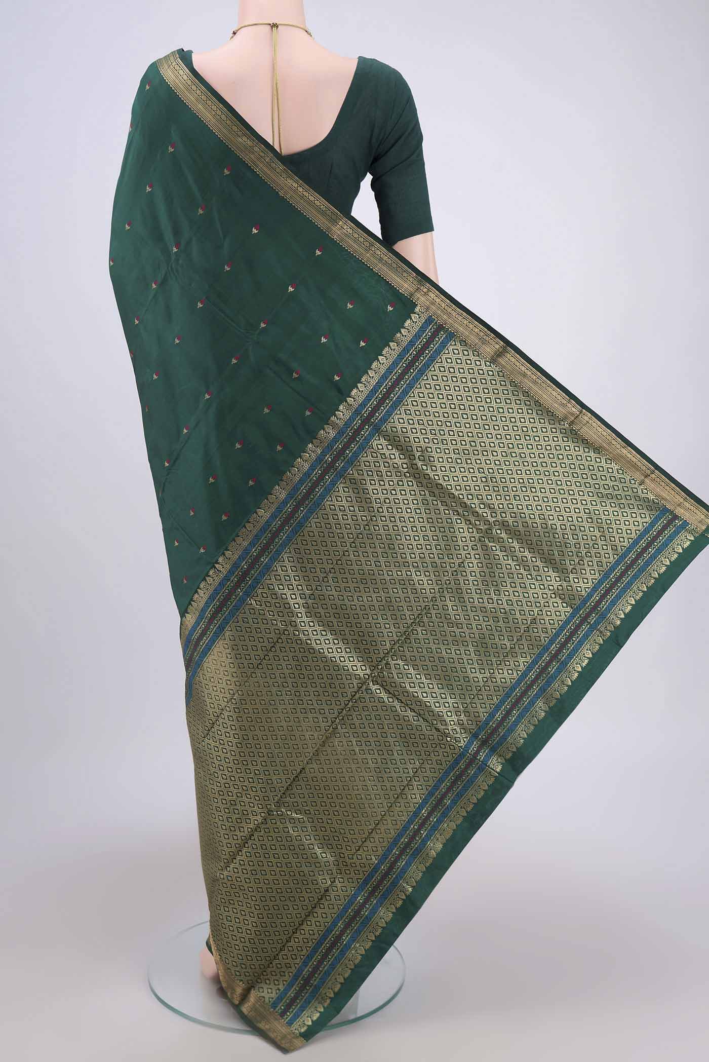 Flat view of Bottle Green Blended Bangalore Silk Saree with Zari And Thread Butta on the body and Zari Border. 