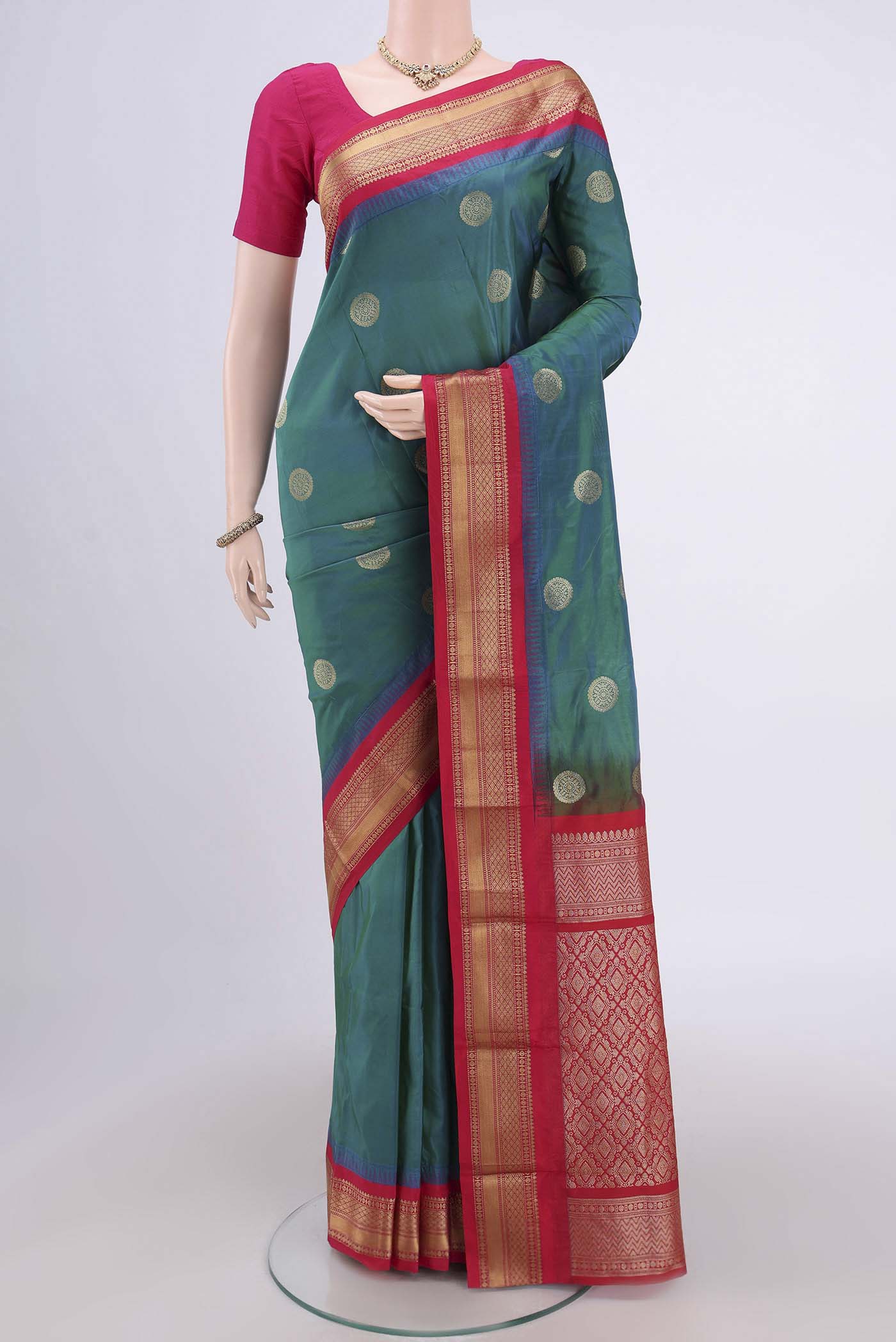 Peacock Blue Blended Bangalore Silk Saree with Zari Butta on the body and Zari Border.  displayed on a mannequin