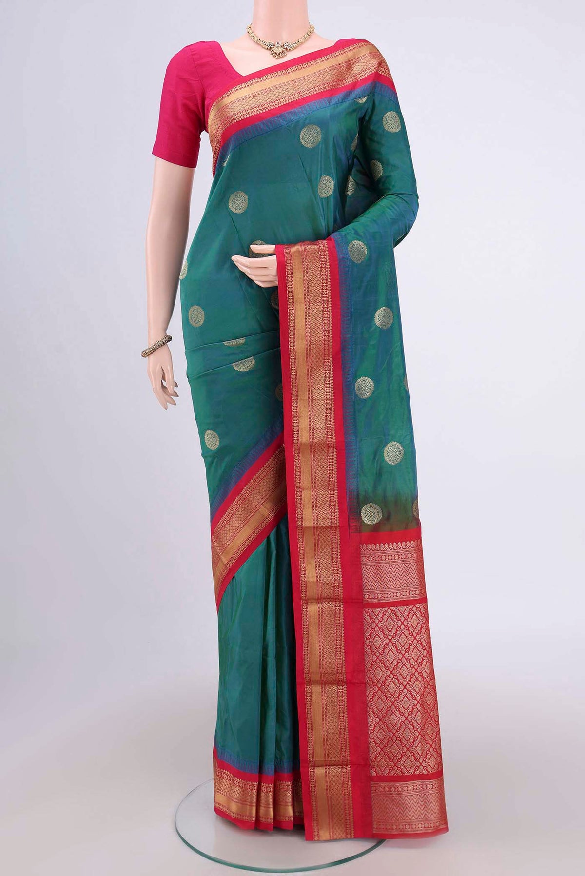 Peacock Blue Blended Bangalore Silk Saree with Zari Butta on the body and Zari Border.  displayed on a mannequin