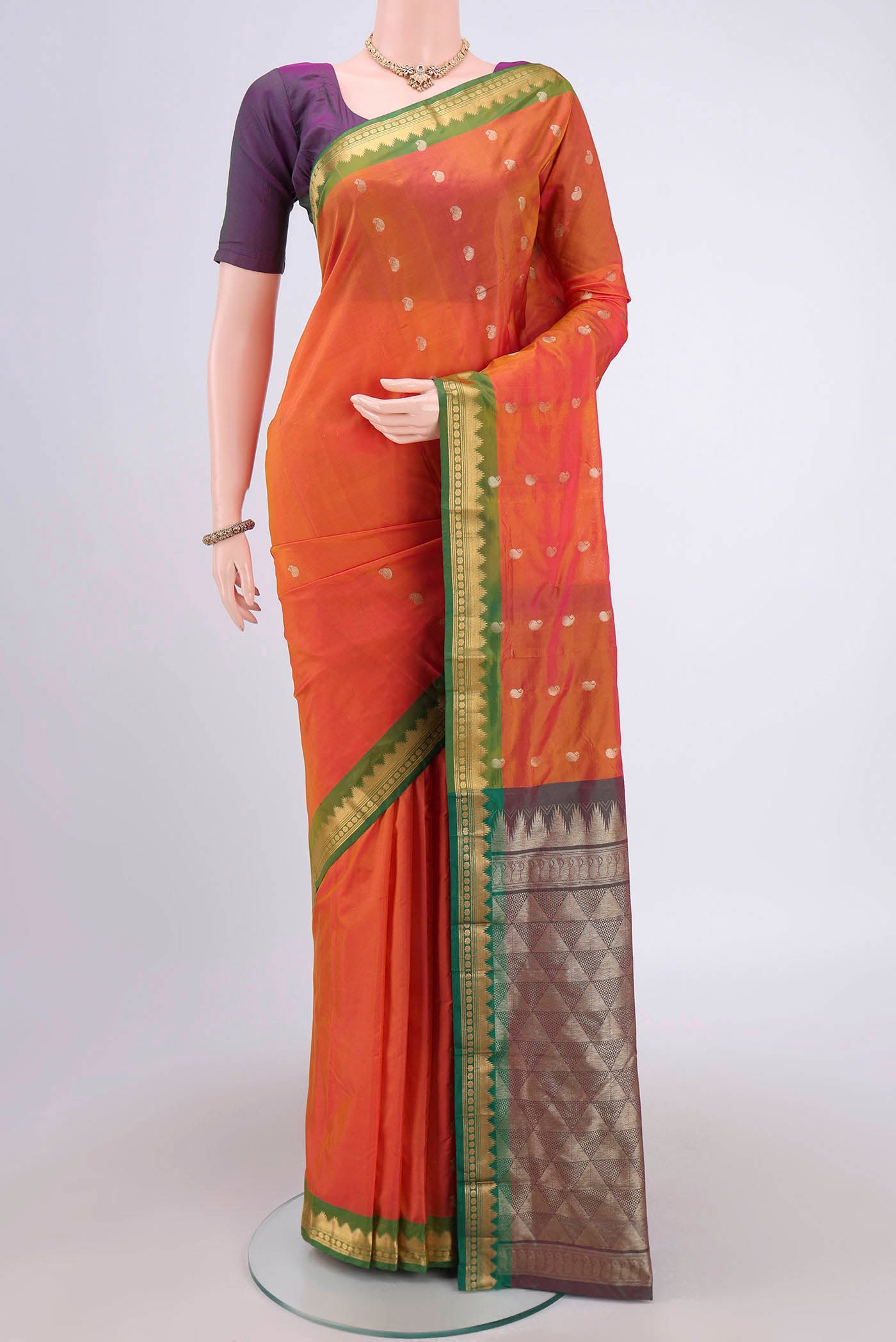 Brick Orange Blended Bangalore Silk Saree with Zari Butta on the body and Zari Border.  displayed on a mannequin