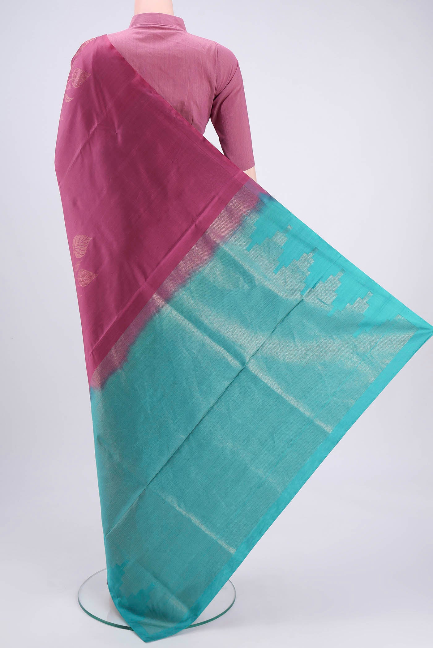 Flat view of Dark Mauve Dual Tone Soft Silk Saree with Zari Butta on the body and Plain Border. 