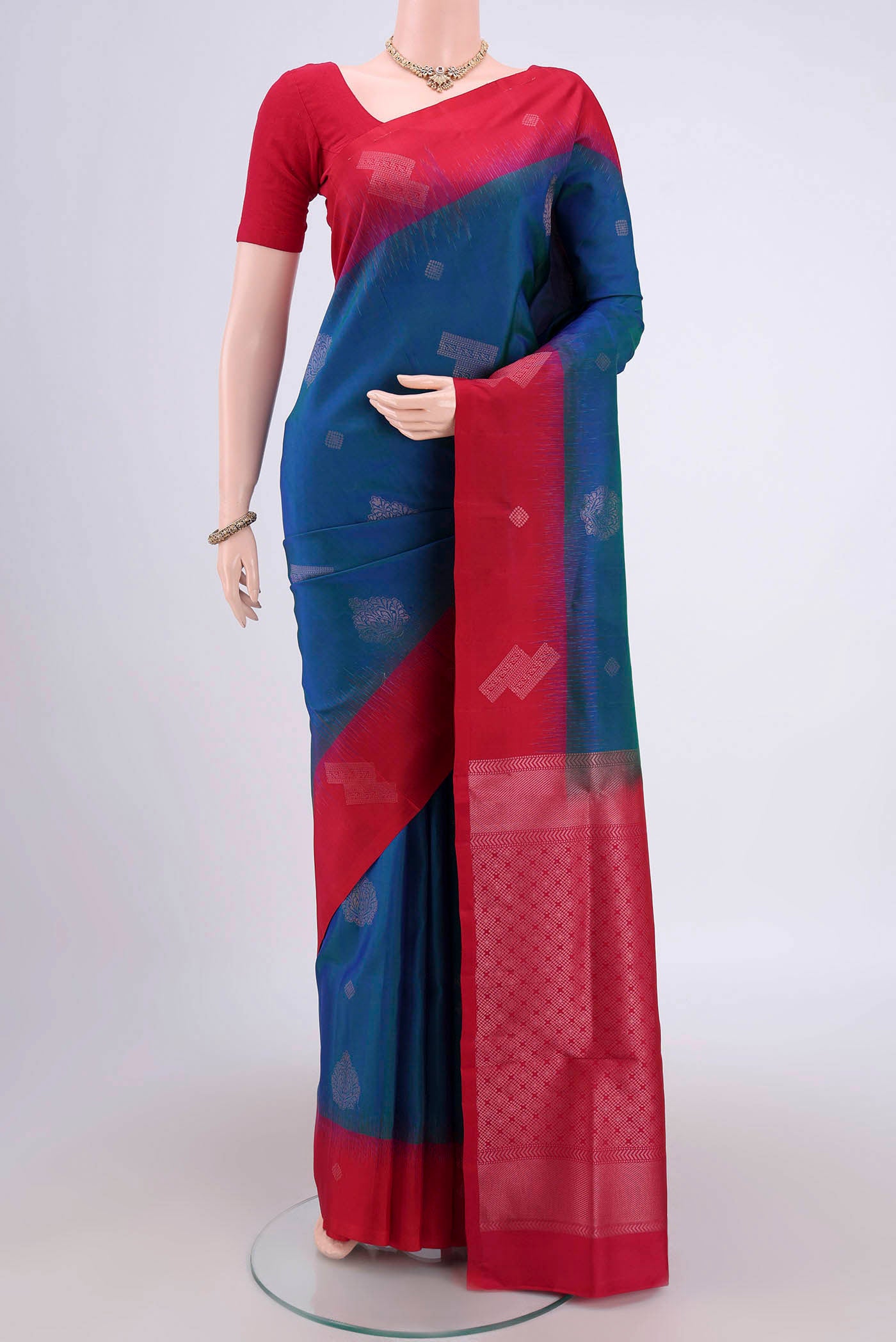 Turquoise Soft Silk Saree with Zari Butta on the body and Zari Border.  displayed on a mannequin