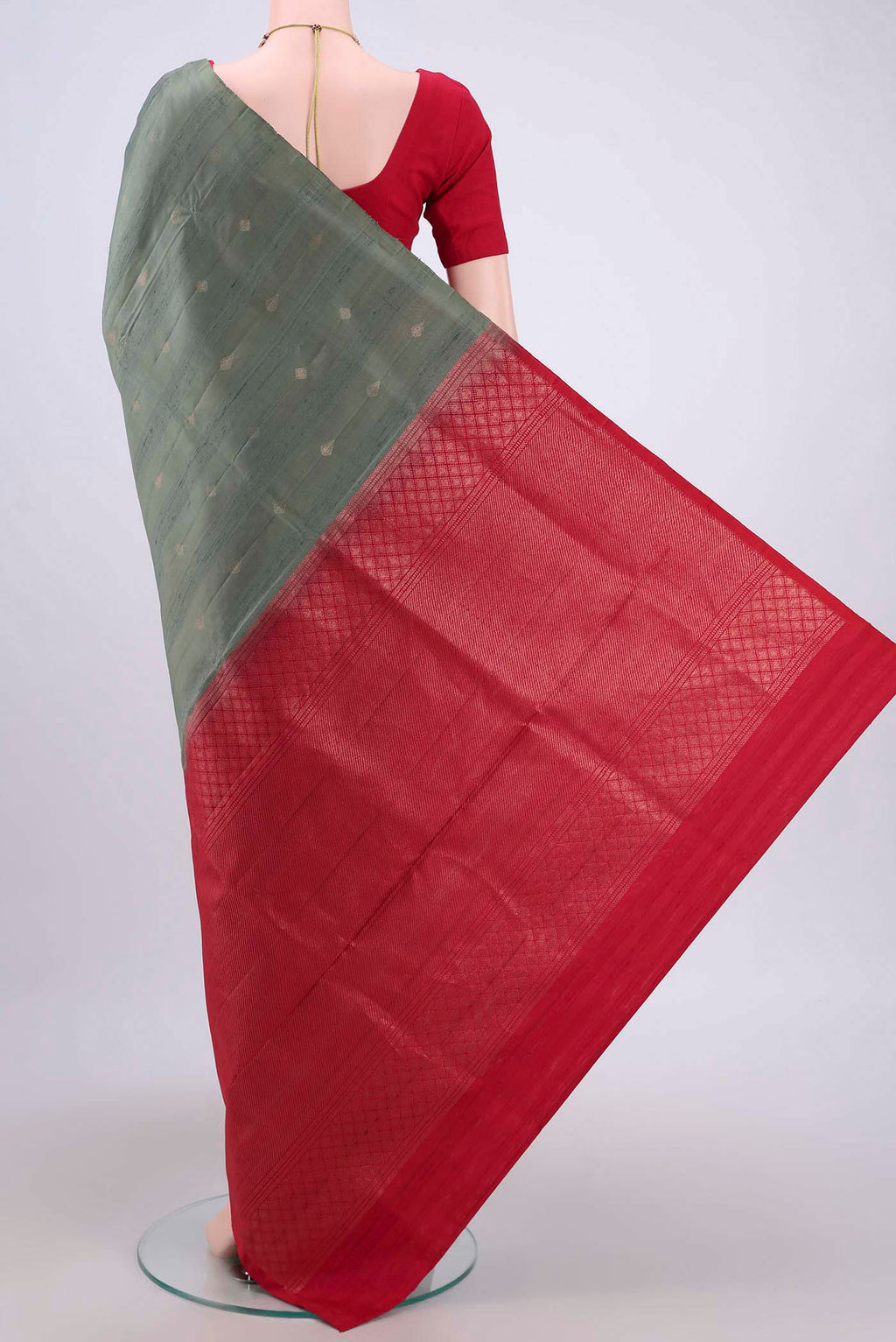 Flat view of Pista Green Soft Silk Saree with Zari Butta on the body and Zari Border. 