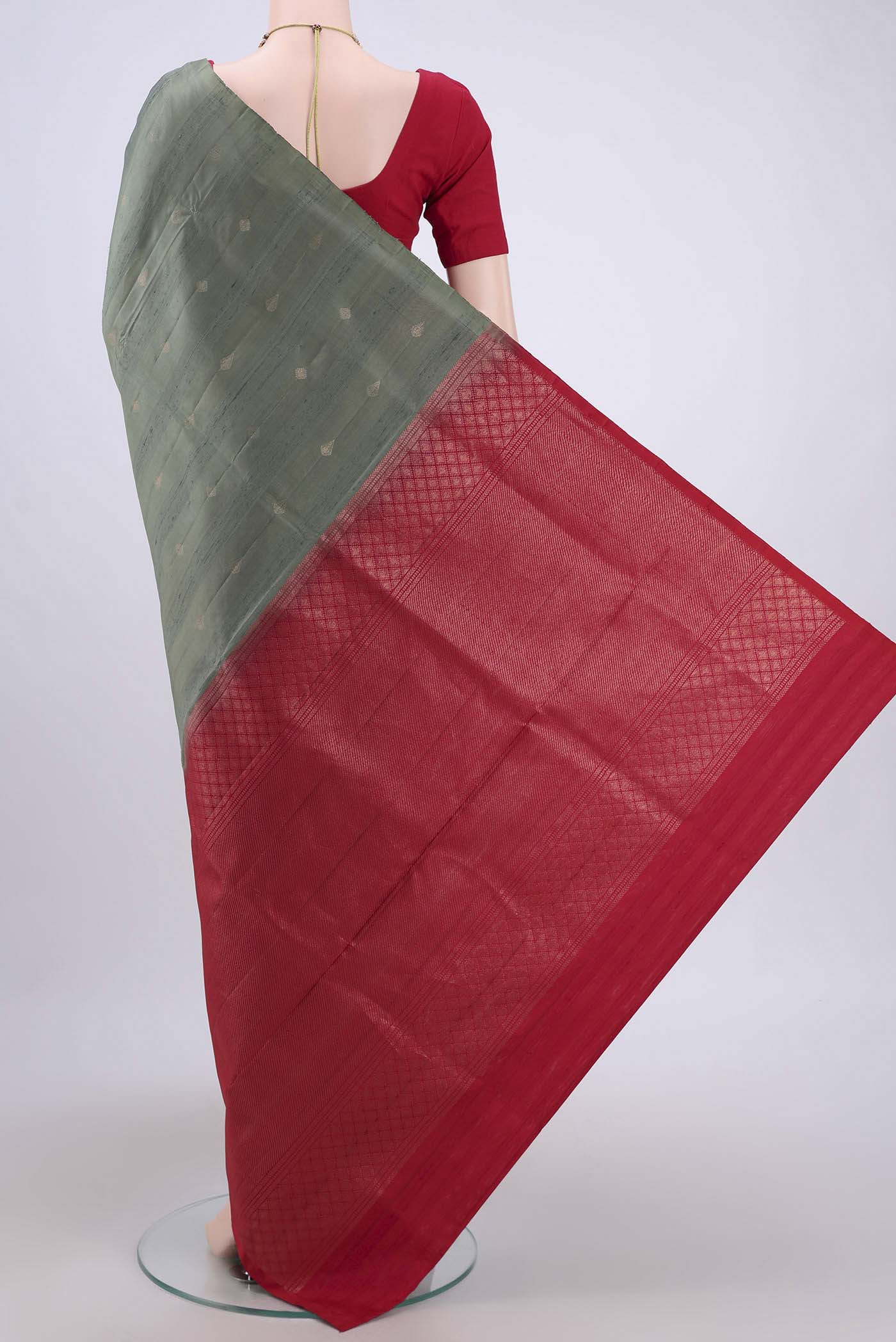 Flat view of Pista Green Soft Silk Saree with Zari Butta on the body and Zari Border. 