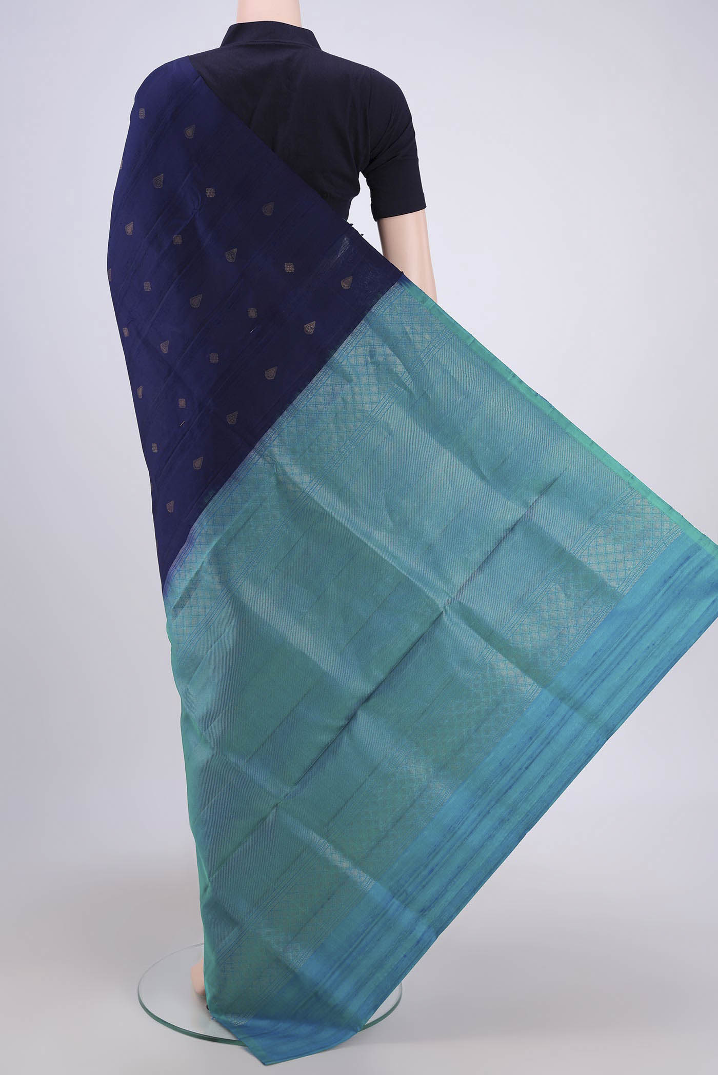 Flat view of Navy Blue Soft Silk Saree with Zari Butta on the body and Zari Border. 