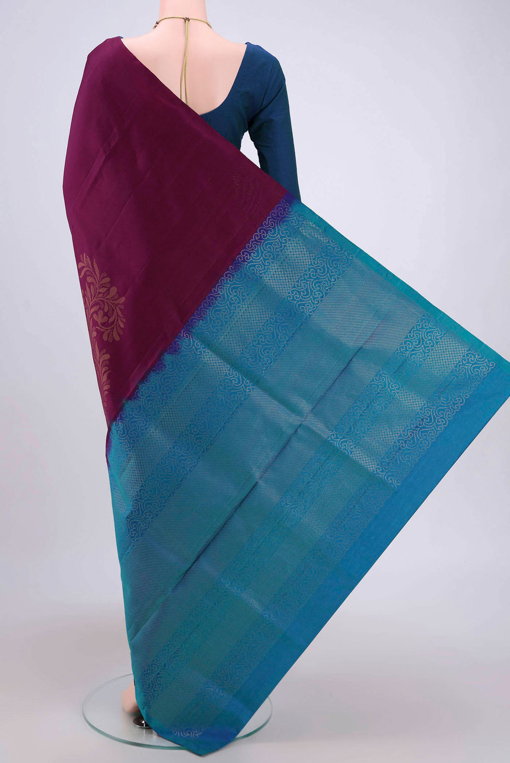 Flat view of Burgundy Soft Silk Saree with Zari Butta on the body and Zari Border. 