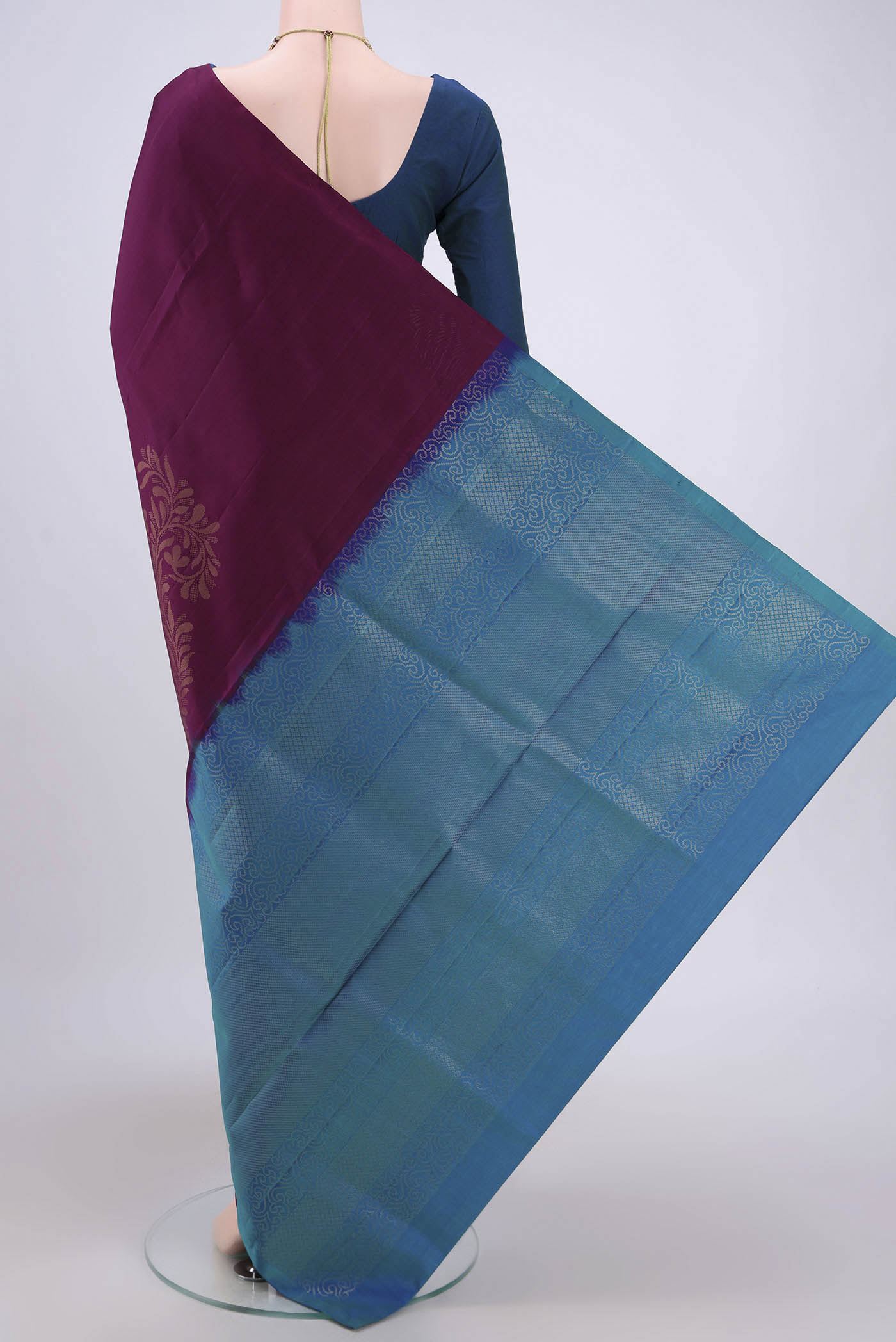 Flat view of Burgundy Soft Silk Saree with Zari Butta on the body and Zari Border. 