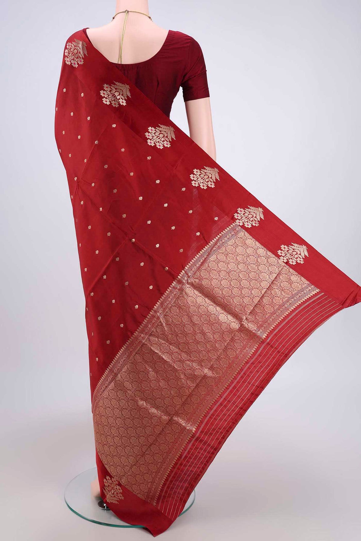 Flat view of Maroon Banarasi Katan Silk Saree with Zari Butta on the body and Zari Border. 
