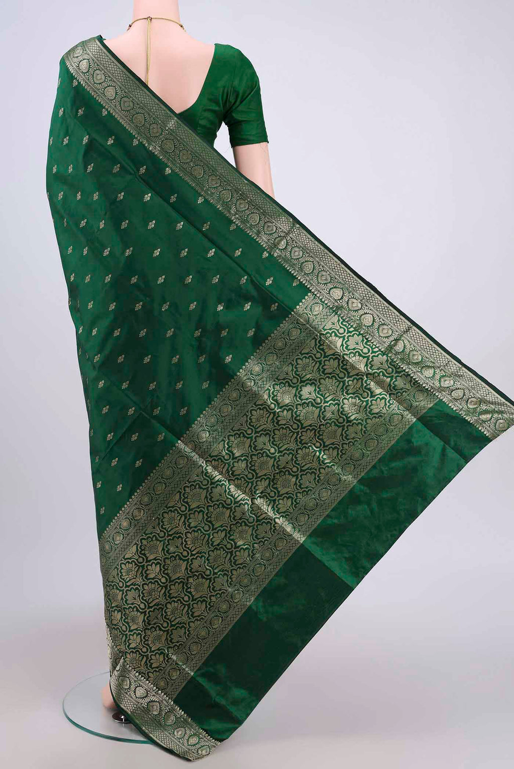 Flat view of Bottle Green Banarasi Katan Silk Saree with Zari Butta on the body and Zari Border. 