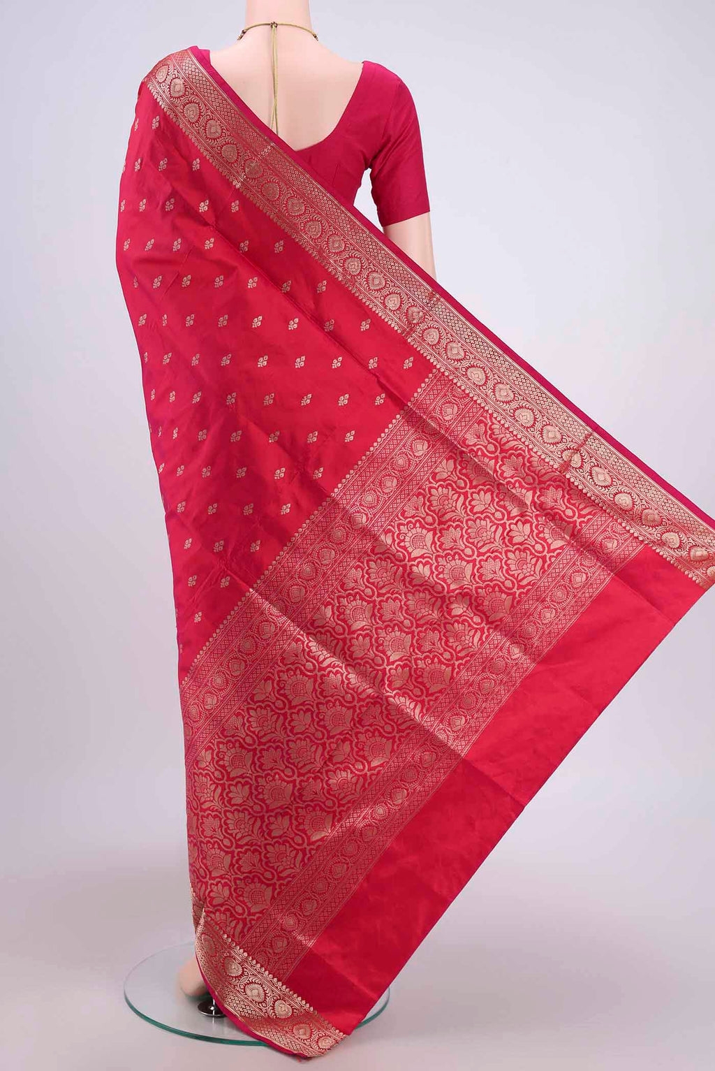 Flat view of Dark Pink Banarasi Katan Silk Saree with Zari Butta on the body and Zari Border. 